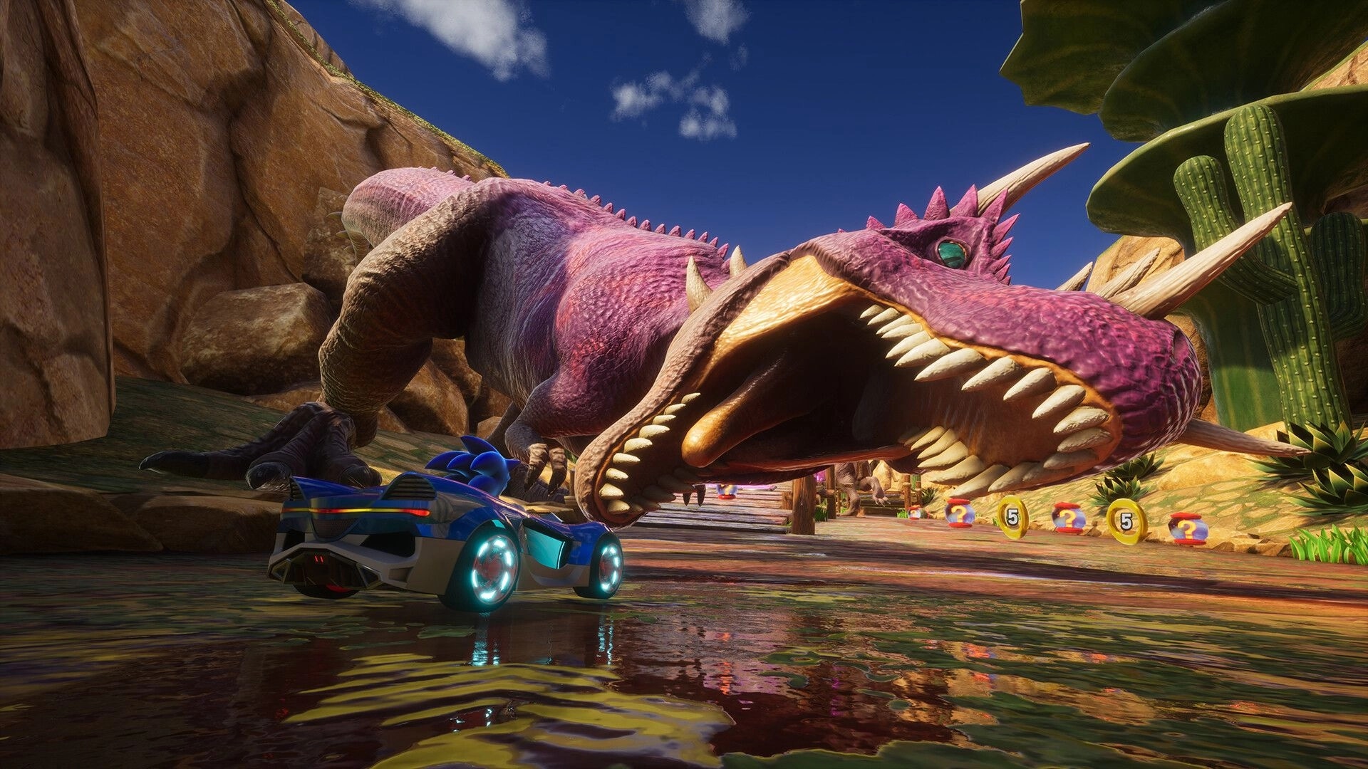 Sonic Racing: Sonic in a race car evades a giant dinosaur in a desert canyon with item boxes nearby
