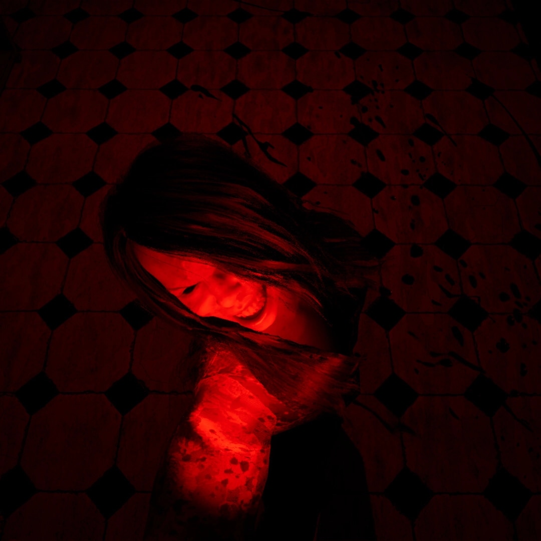 Spiritus Sancti: Bloodied woman lies on red-tiled floor under harsh red light, close-up view.
