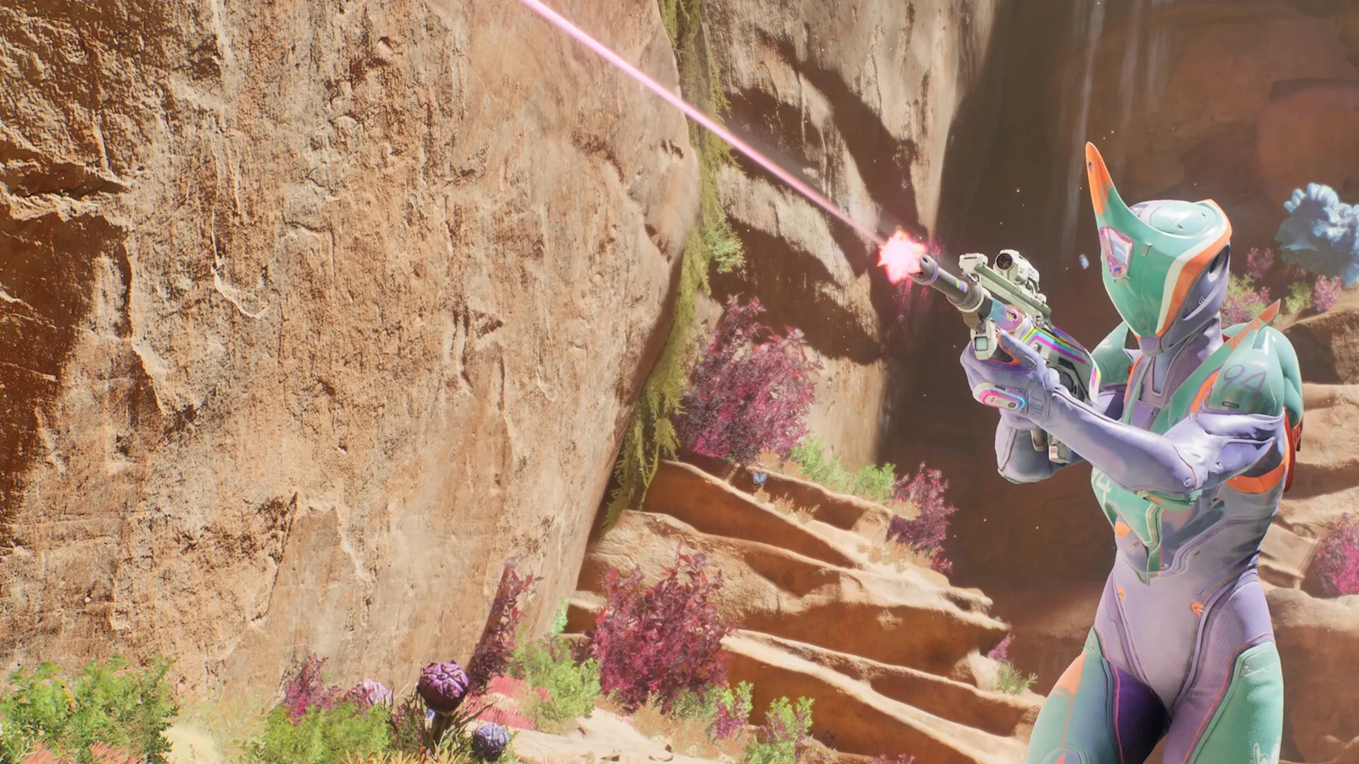 Splitgate 2: Armored character firing a weapon in a colorful canyon environment with rocky walls