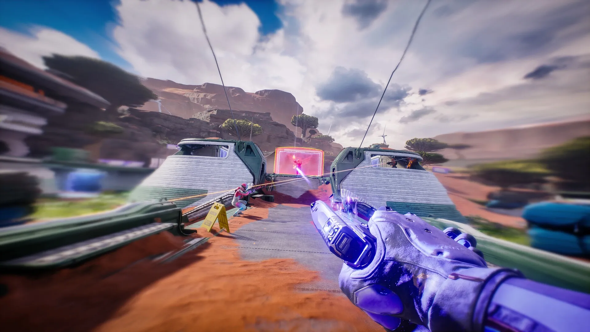 Splitgate 2: Player firing weapon through portal in futuristic desert terrain with enemy in sight