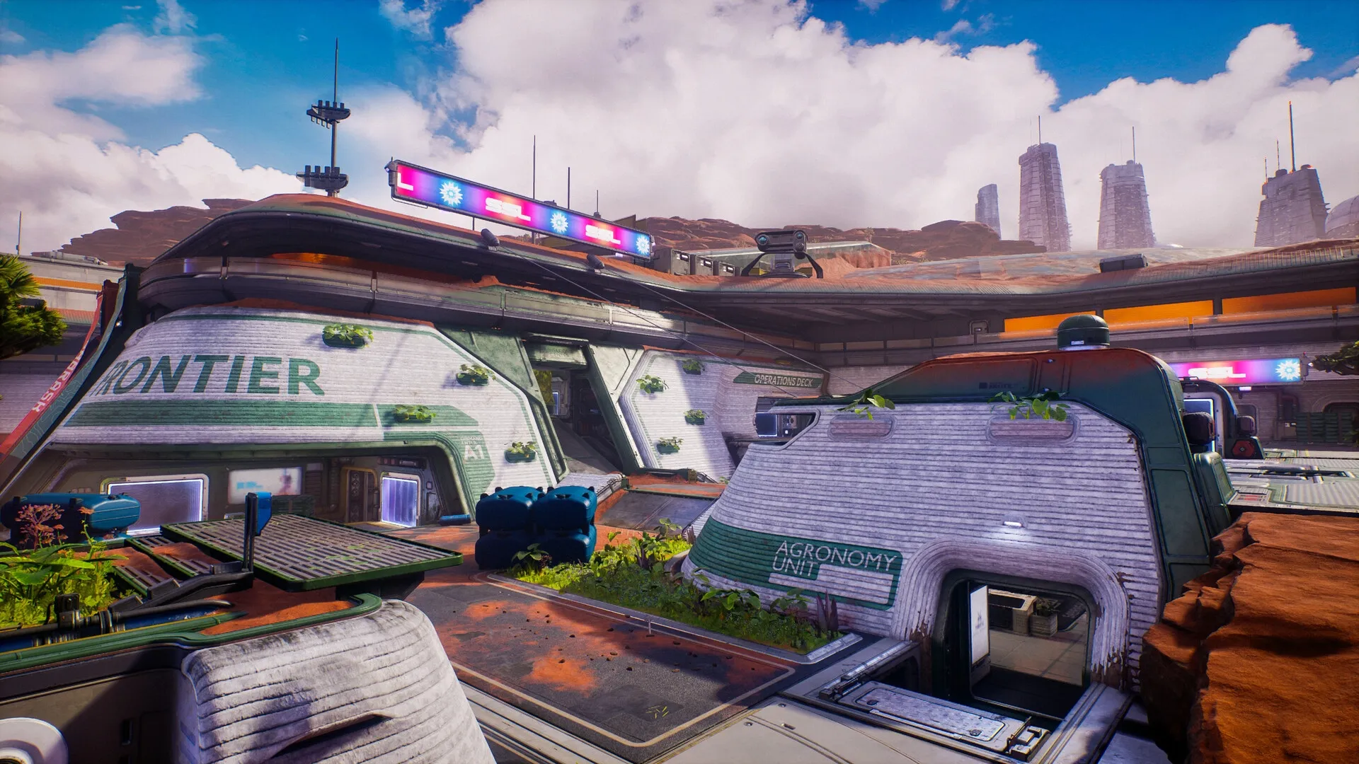 Splitgate 2: Exterior of futuristic agronomy unit with green plants and industrial buildings in desert setting