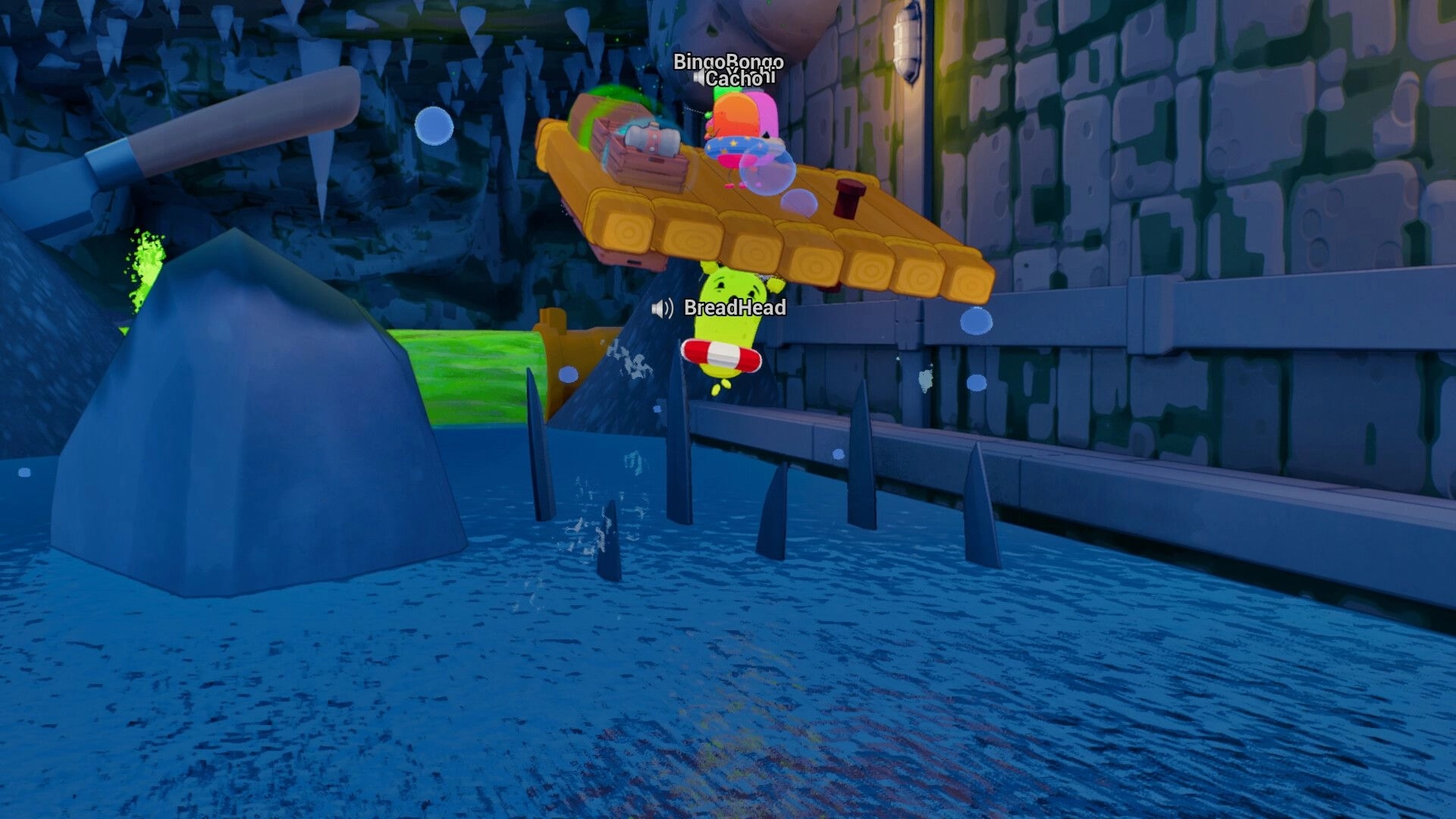 Sponge Break: Two players on a raft above spikes, BreadHead falling into water in stone tunnel.
