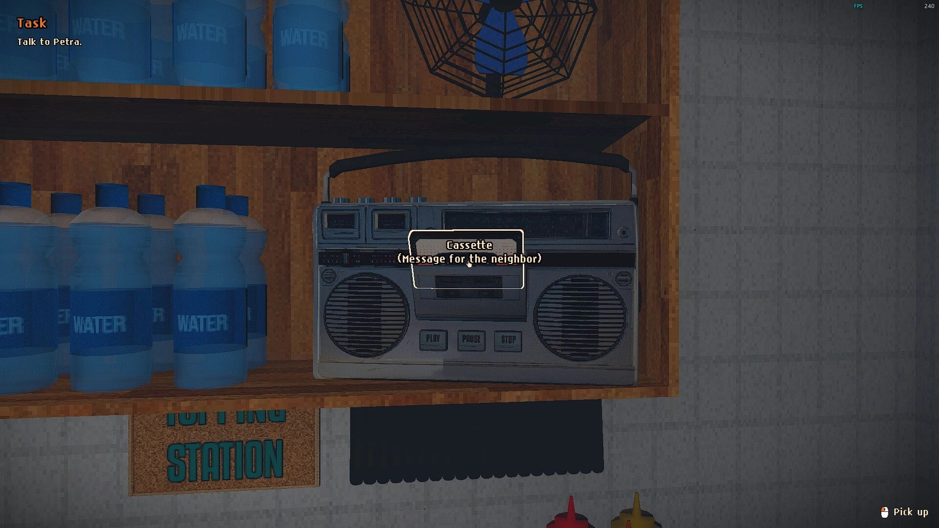 Still Warm: Highlighted cassette in a boombox on a wooden shelf beside water bottles in shop stall.