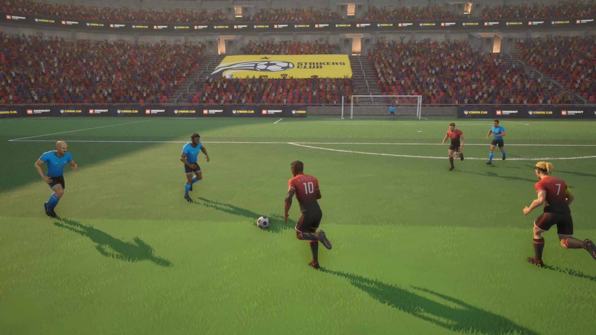 Strikers Club: Player in red jersey dribbling past opponents on a sunny football field in a crowded stadium