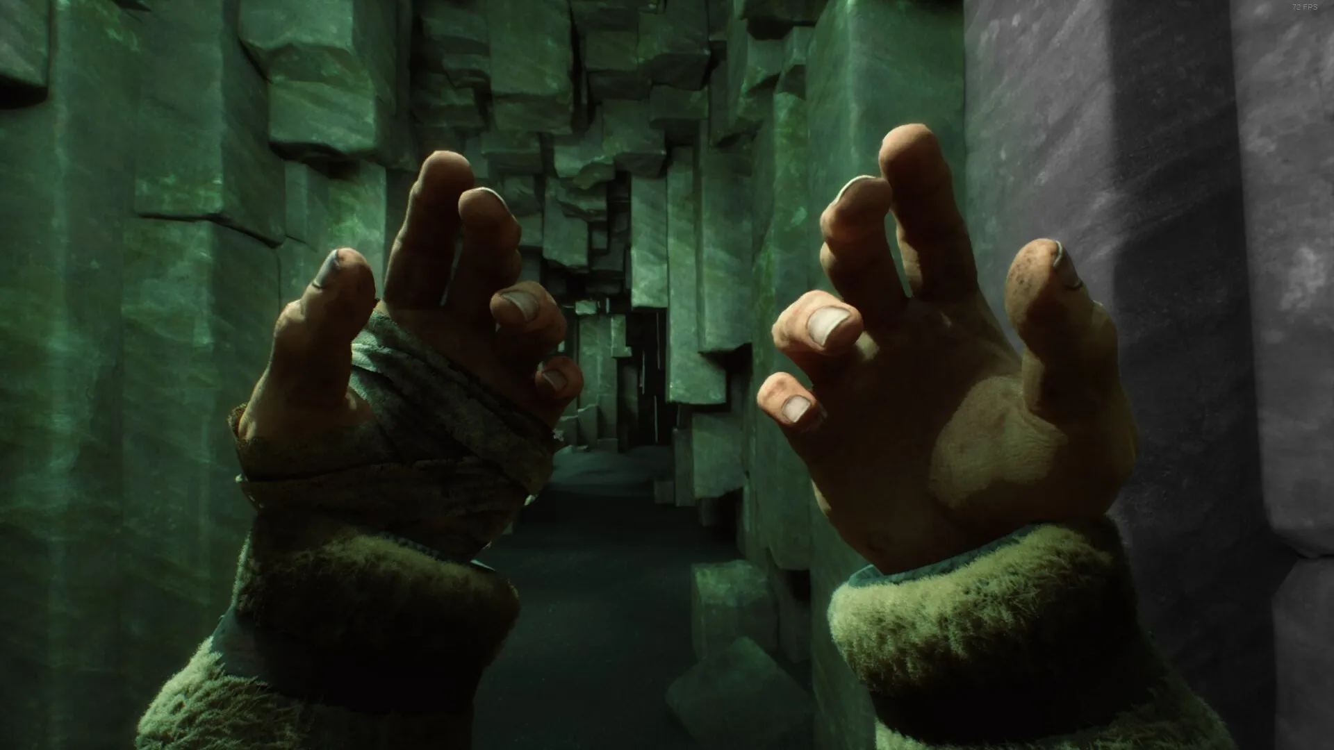 Stygian: First-person view of bandaged hands reaching out in a dimly lit, narrow stone corridor.