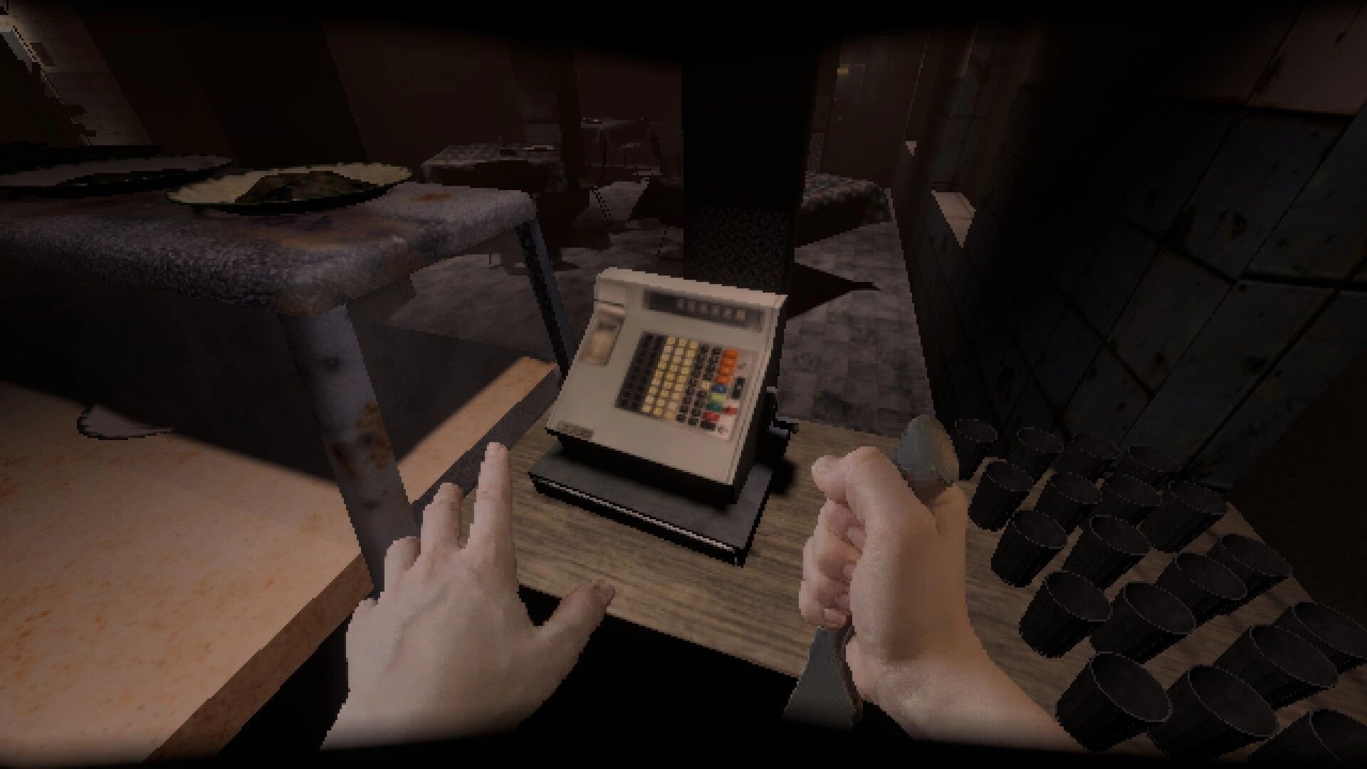 Subjectivation: First-person view holding a knife beside a cash register in a dim, abandoned shop.