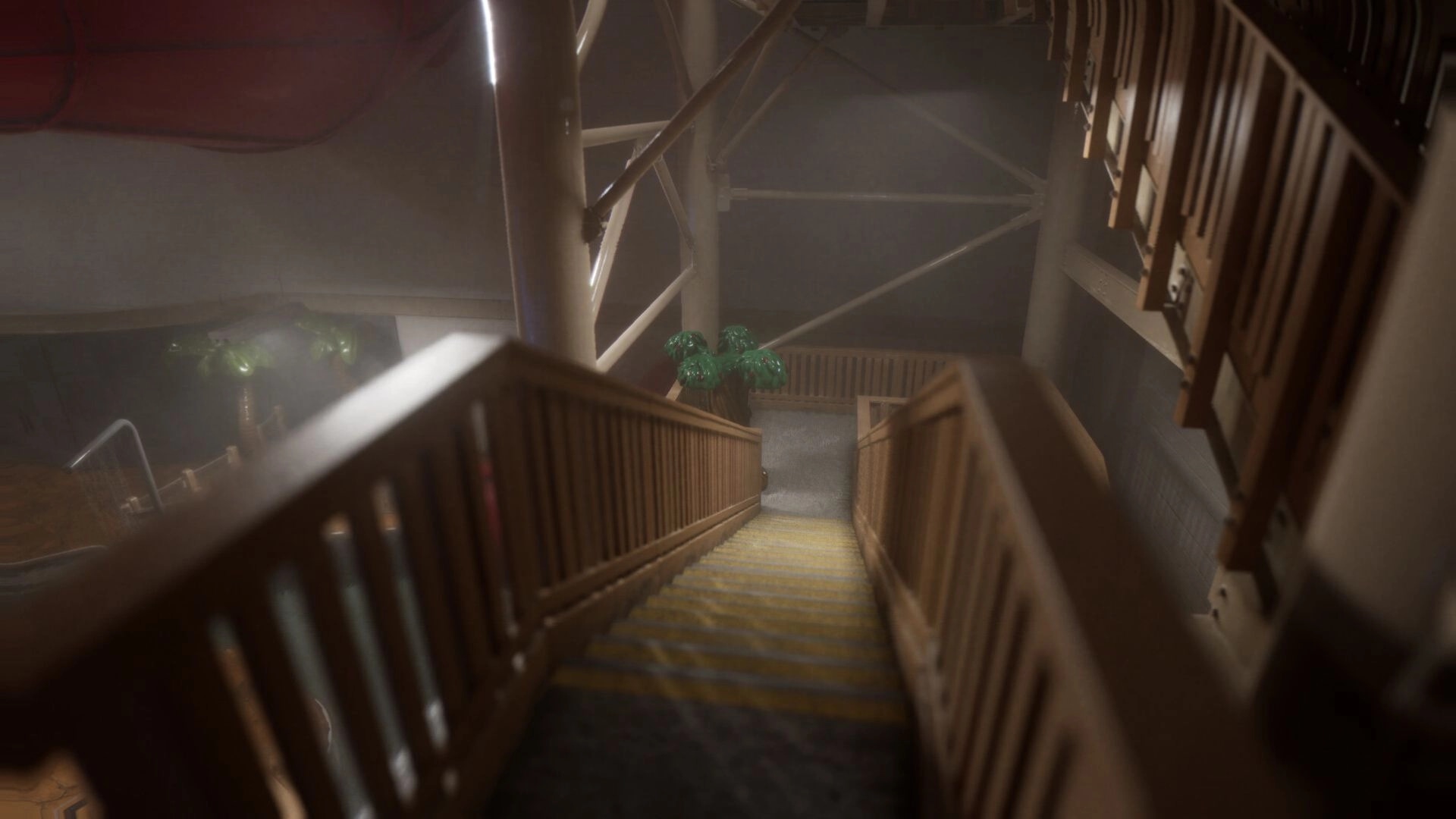 Subliminal: Descending a dimly lit wooden staircase in a surreal, industrial environment with palm plants.