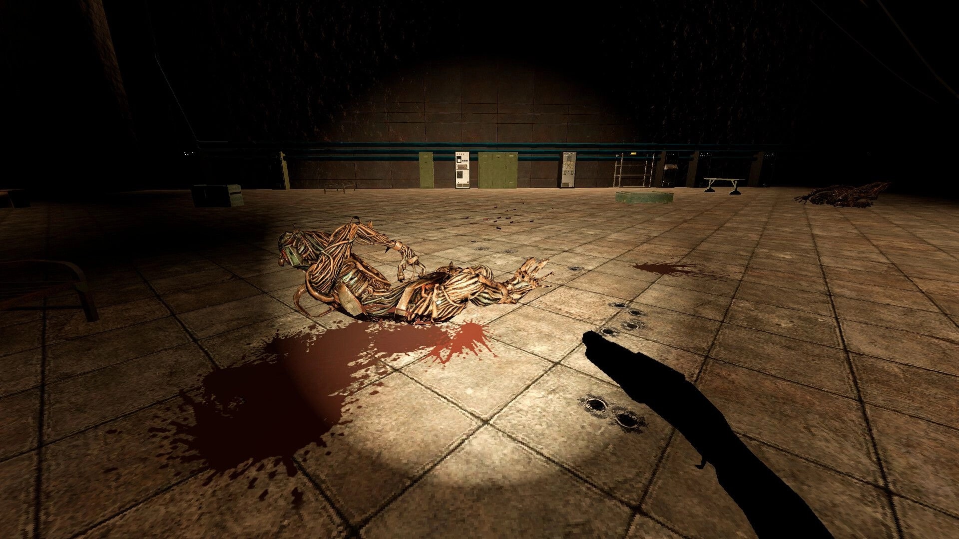 SUPERPANEL: First-person view of a dead mutant on bloodied tiles in a dim industrial room.