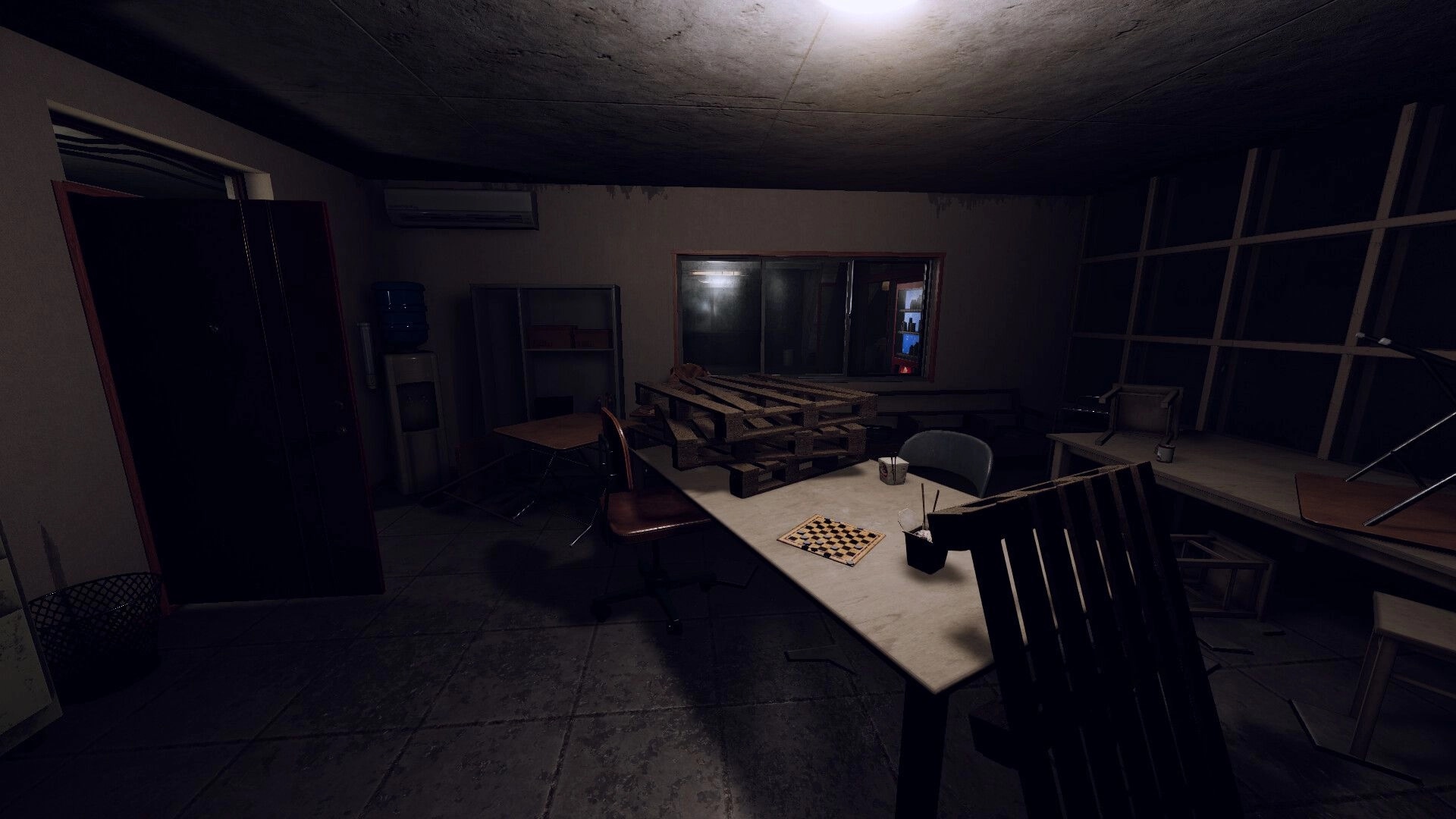 Tales of Fear: Dimly lit room with scattered pallets and a chessboard on table, creating eerie atmosphere