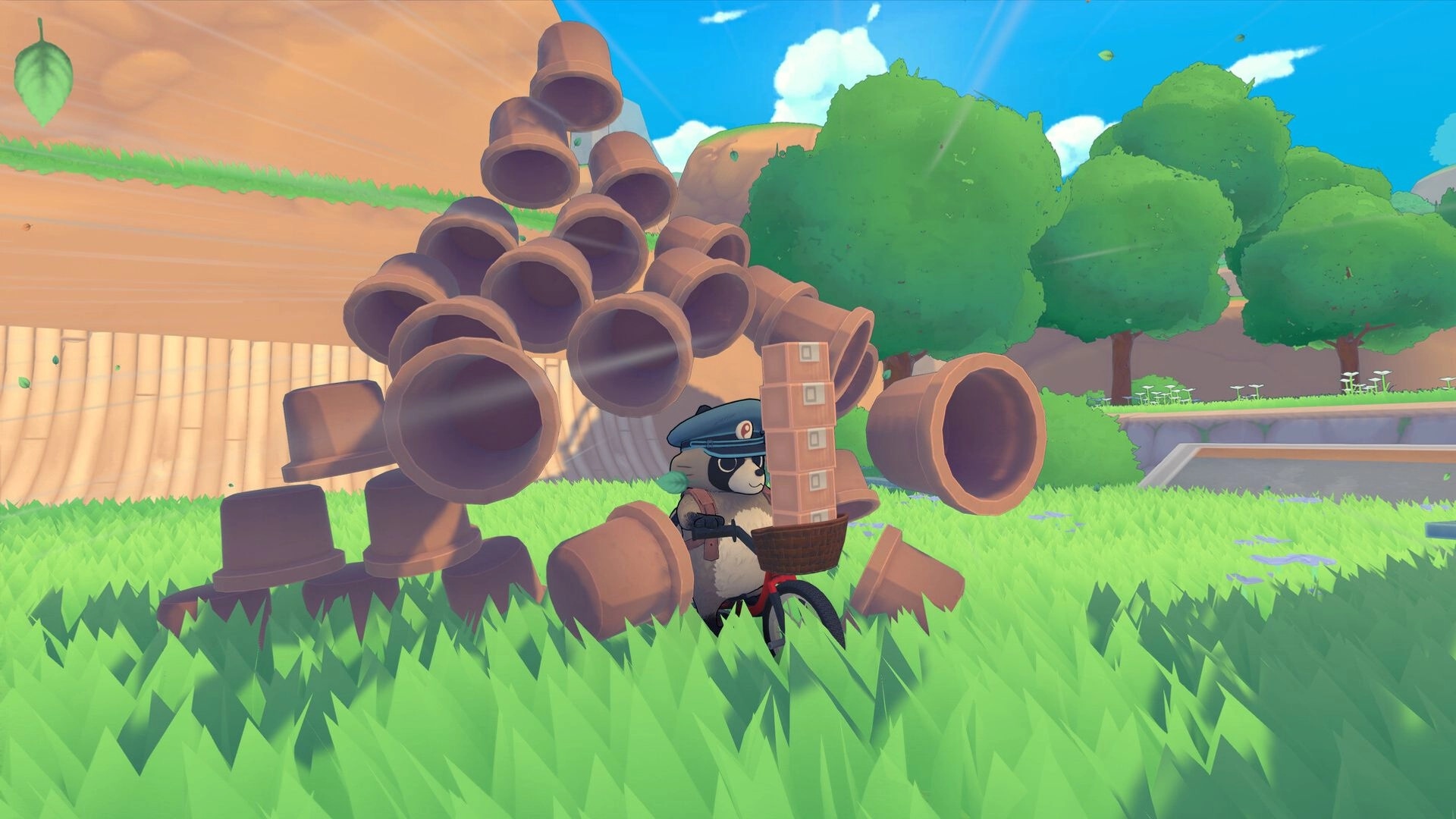 TANUKI: Pon delivering packages on a bike beside stacked pots in a grassy, sunlit park area.