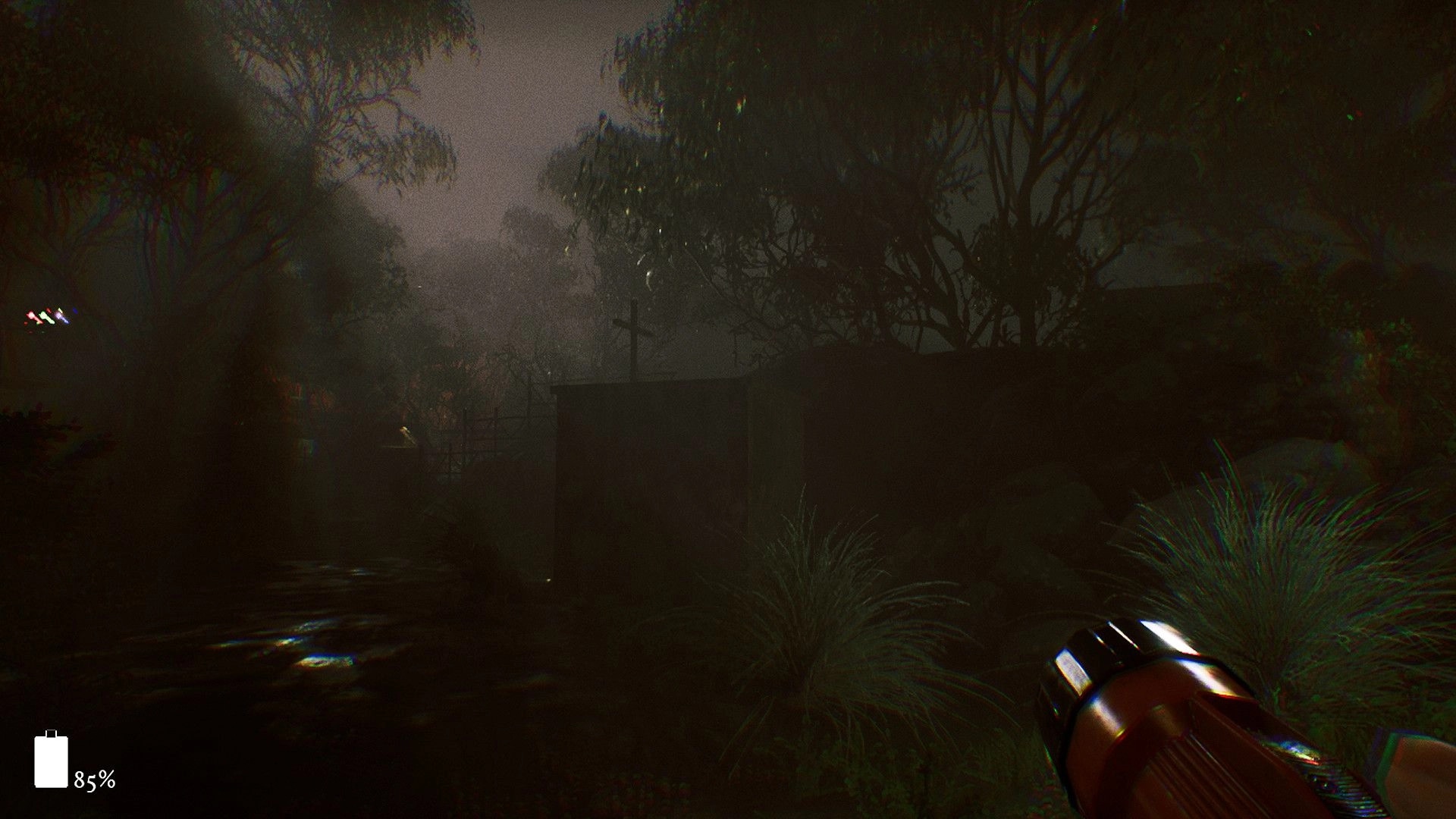 The 9th Charnel: Exploring dark forest with flashlight in hand, battery level at 85% on screen