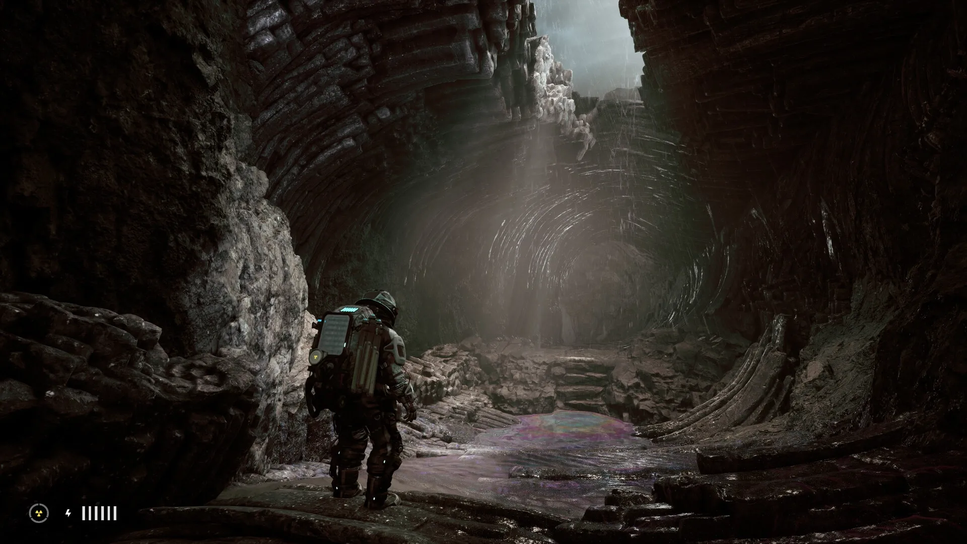 The Alters: Jan Dolski exploring a rocky cave environment with mysterious light and rugged terrain