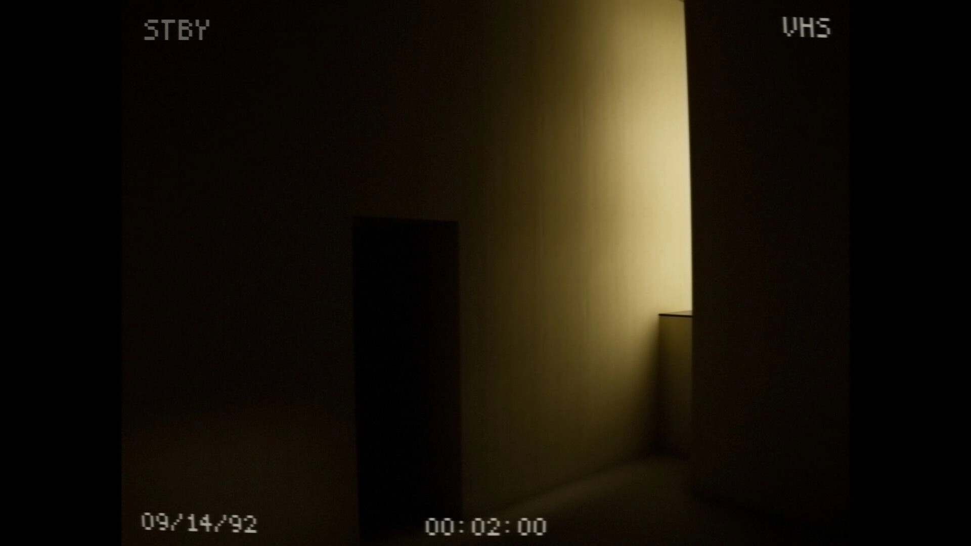 The Backrooms: VHS camera view of a dim yellow hallway corner with STBY and timestamp overlays.