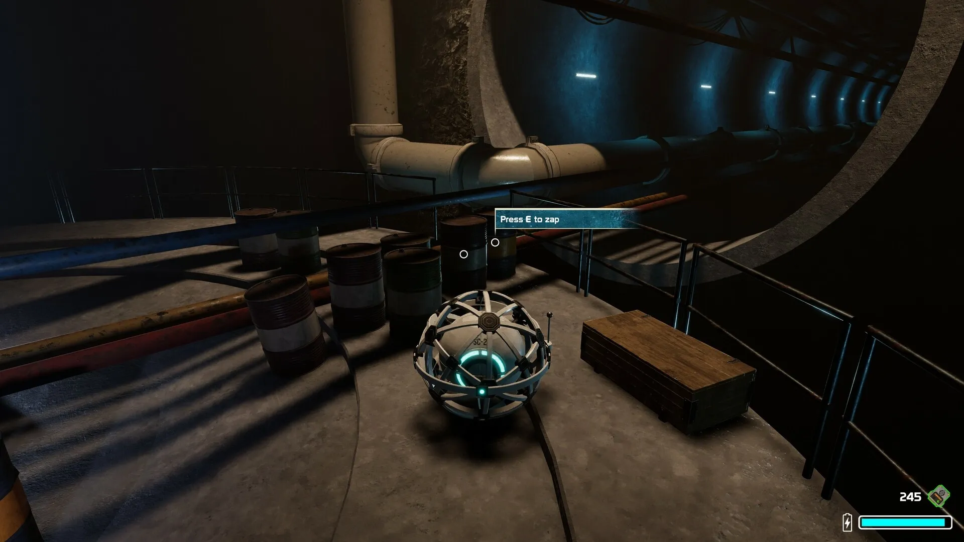 The Core: AI core exploring dimly lit facility with pipes and barrels, prompt to press E to zap
