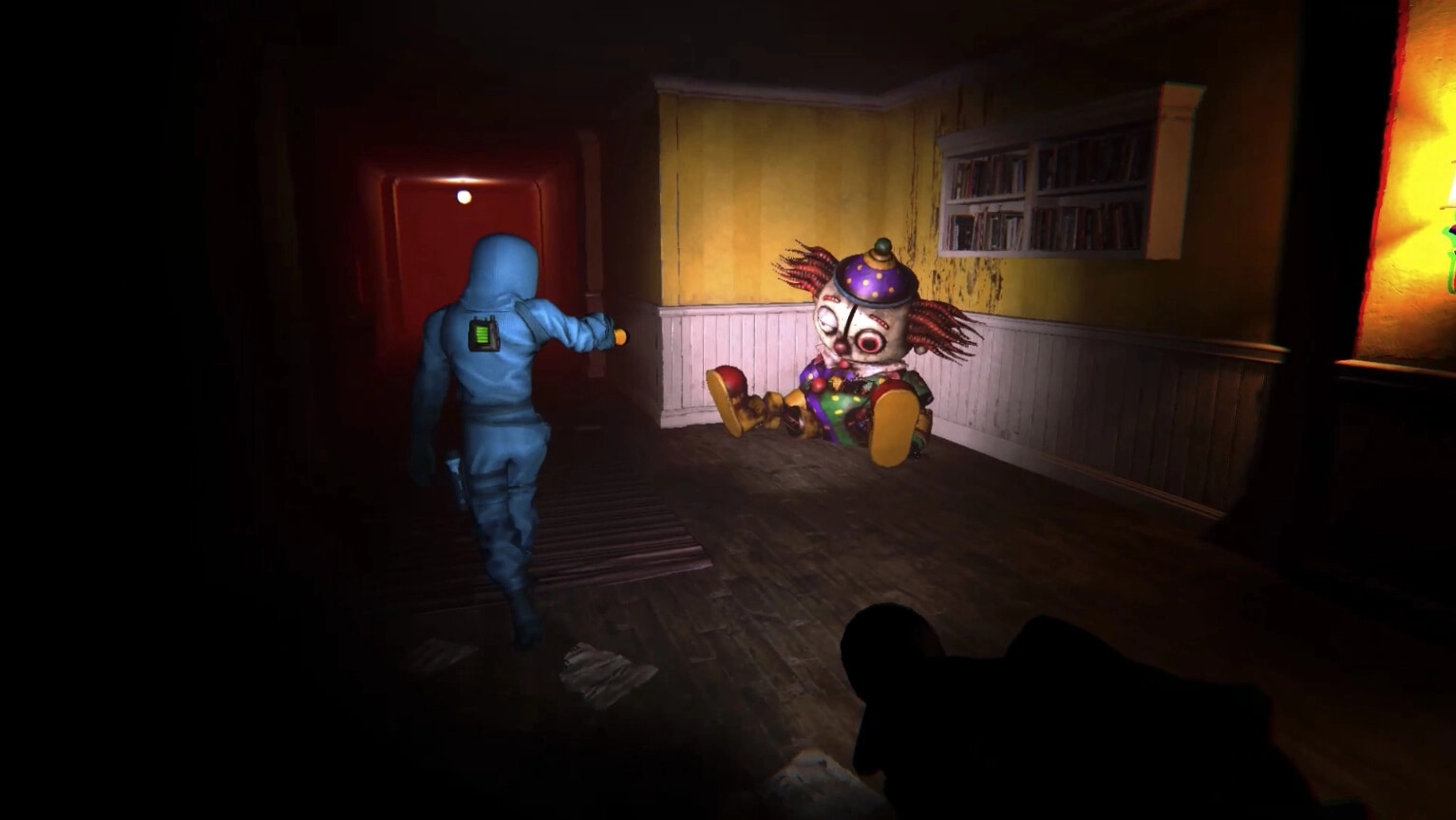 The Doorway Effect: Player in blue suit approaches giant clown in dimly lit hallway with red glow