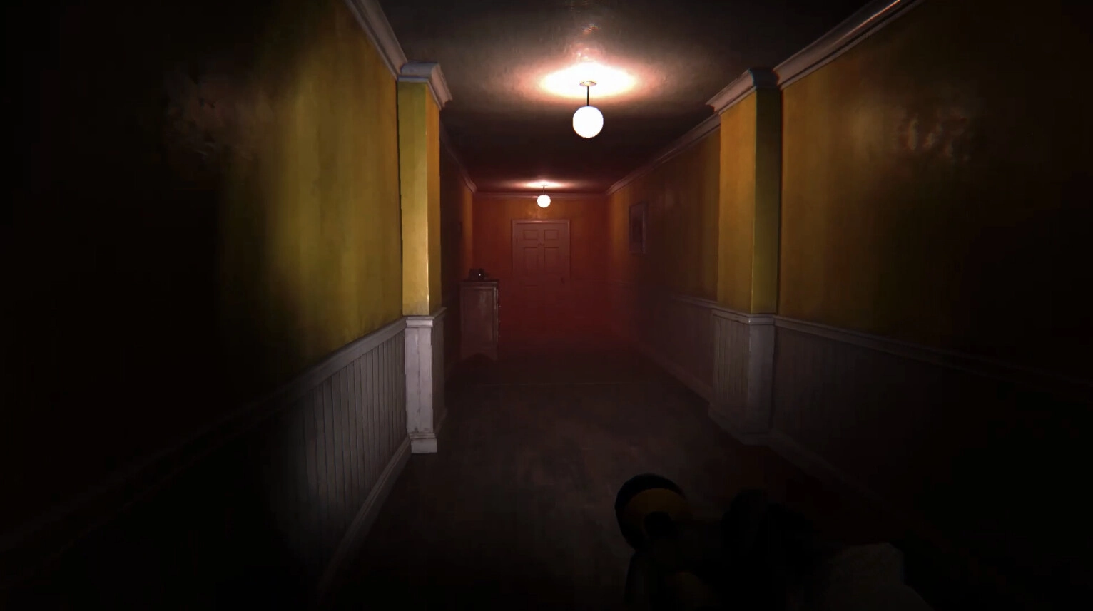 The Doorway Effect: Dimly lit hallway with yellow walls and closed door, flashlight illuminating path