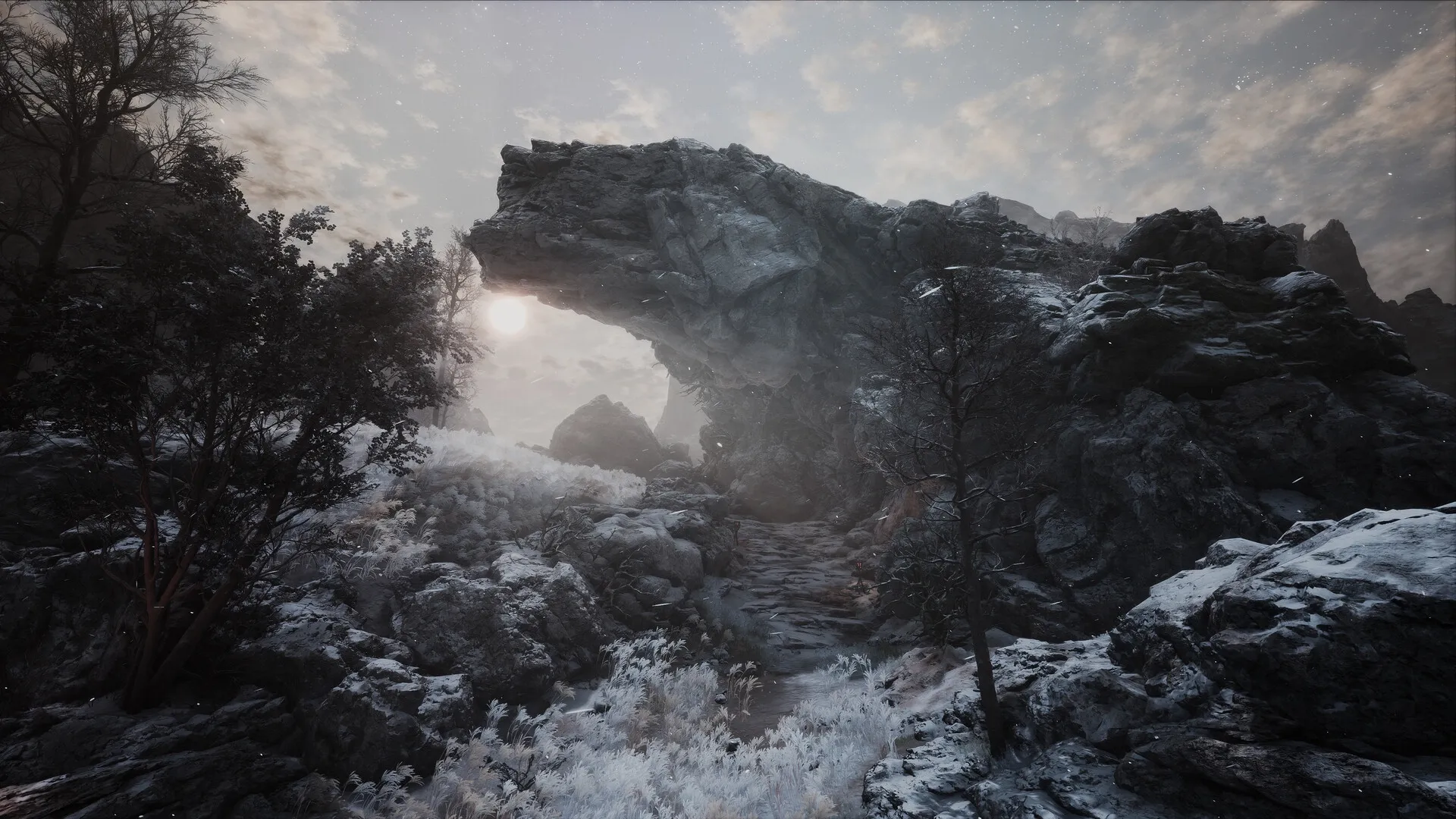 The First Berserker: Snowy rocky landscape with a dramatic sunlit arch in a desolate, wintry environment.