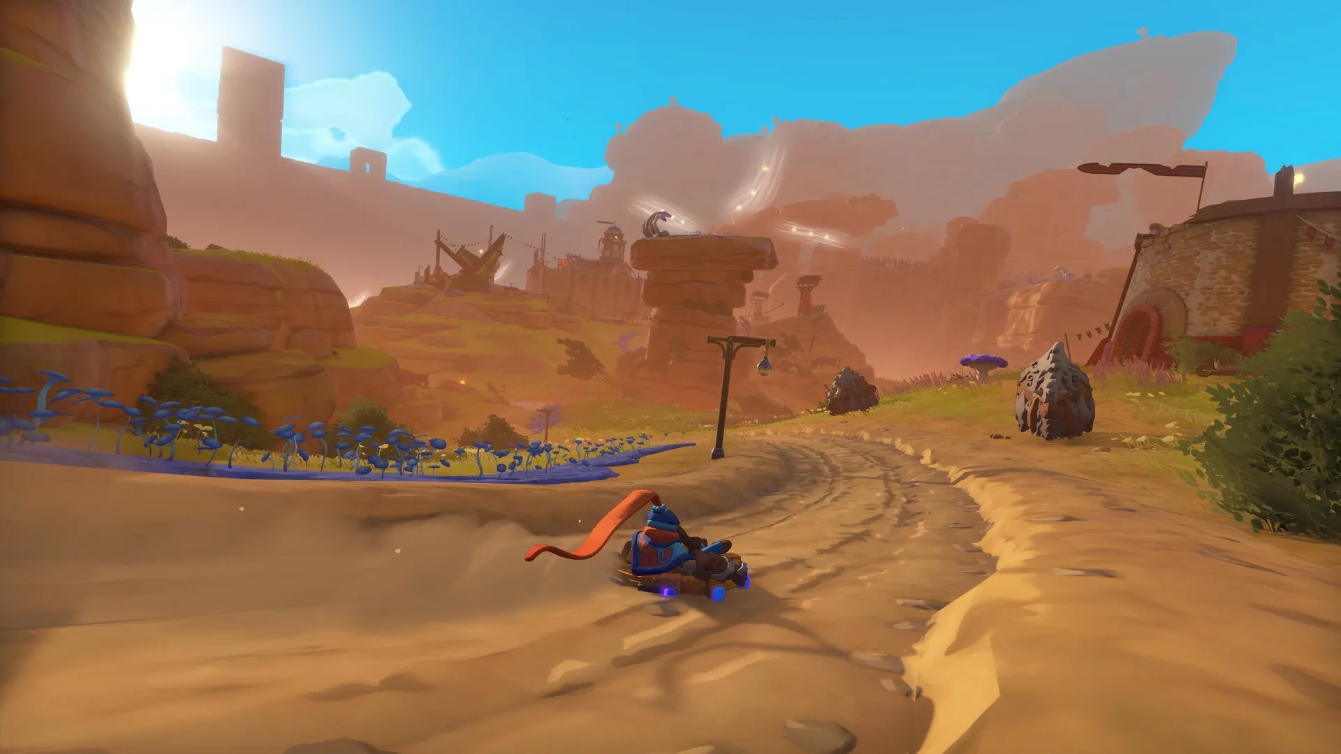 The Knightling: Player rides a cart down a winding dirt path in a colorful canyon with blue mushrooms.