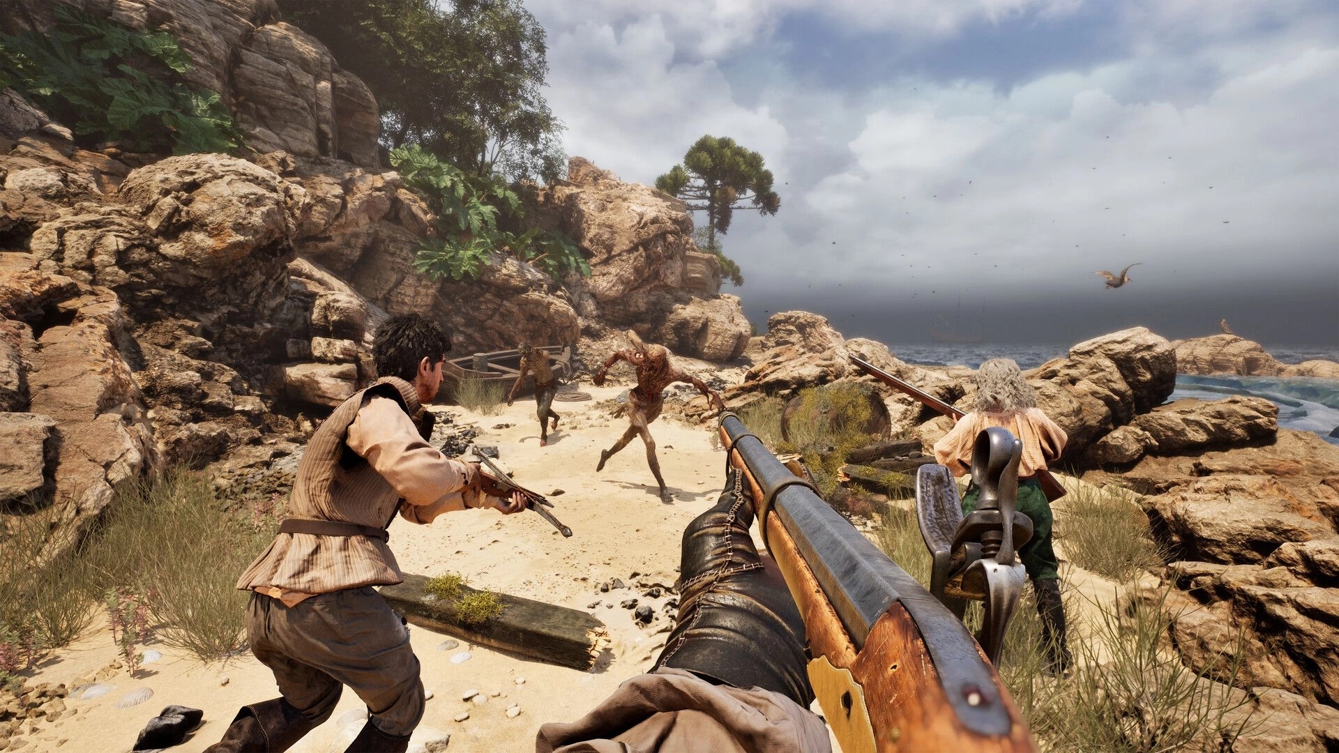 The Mound: First-person rifle aiming as teammates fight a lunging monster on a rocky beach path.