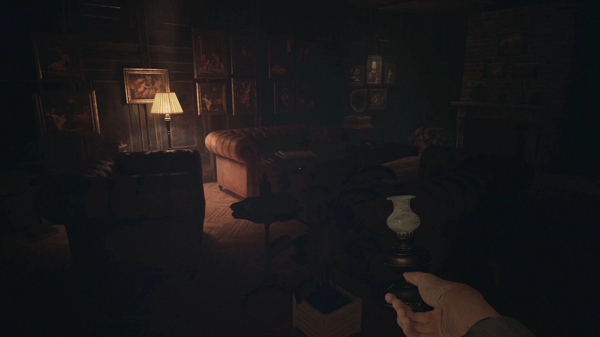 The Patient: Dimly lit sanatorium room with vintage furniture and player holding a lamp in the foreground
