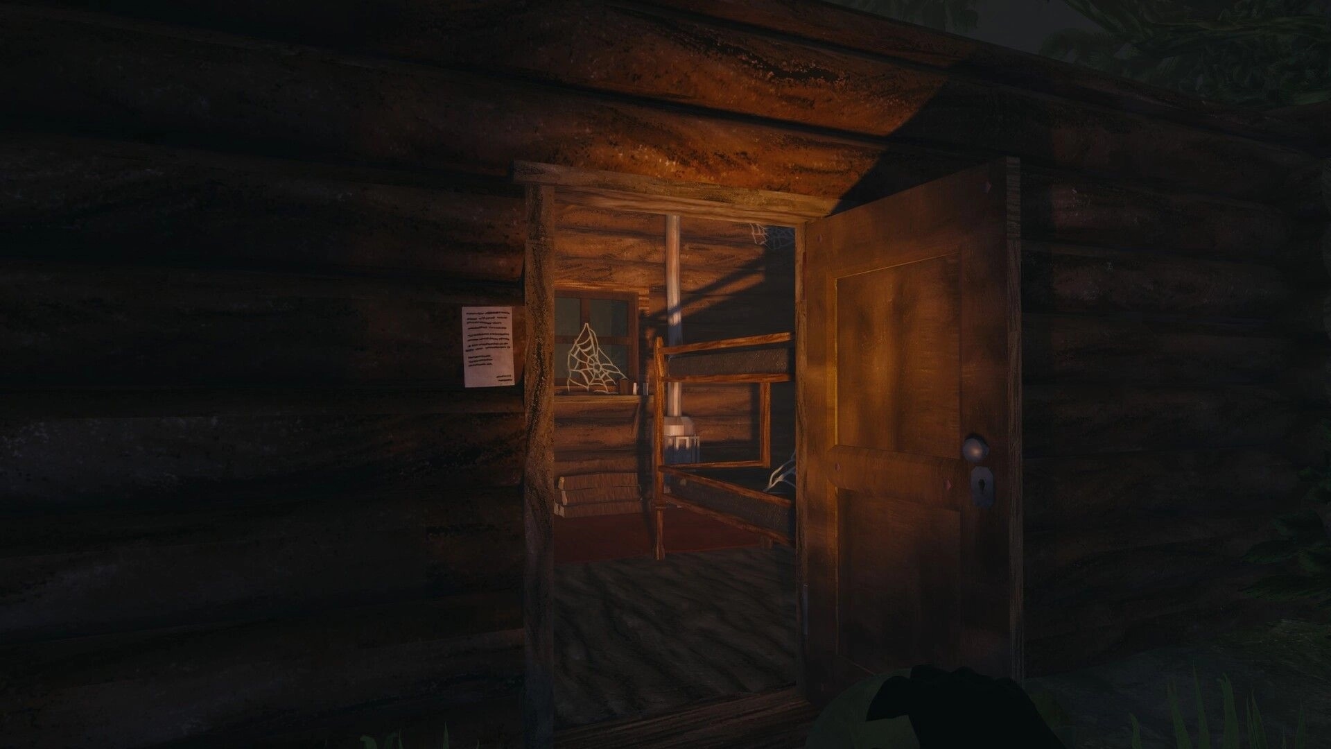 The UNDA Legacy: Open cabin door revealing dusty bunk bed and cobwebs in dim wooden room.