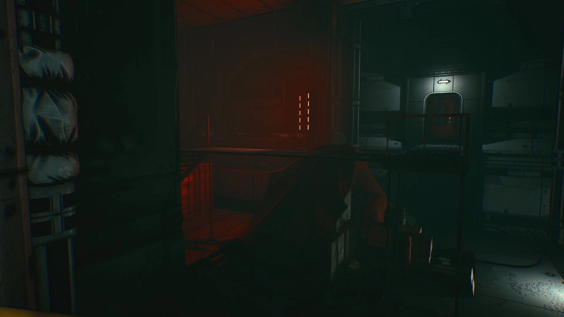 They Left Us Here: First-person view across a catwalk toward a sealed door in a dim space bay