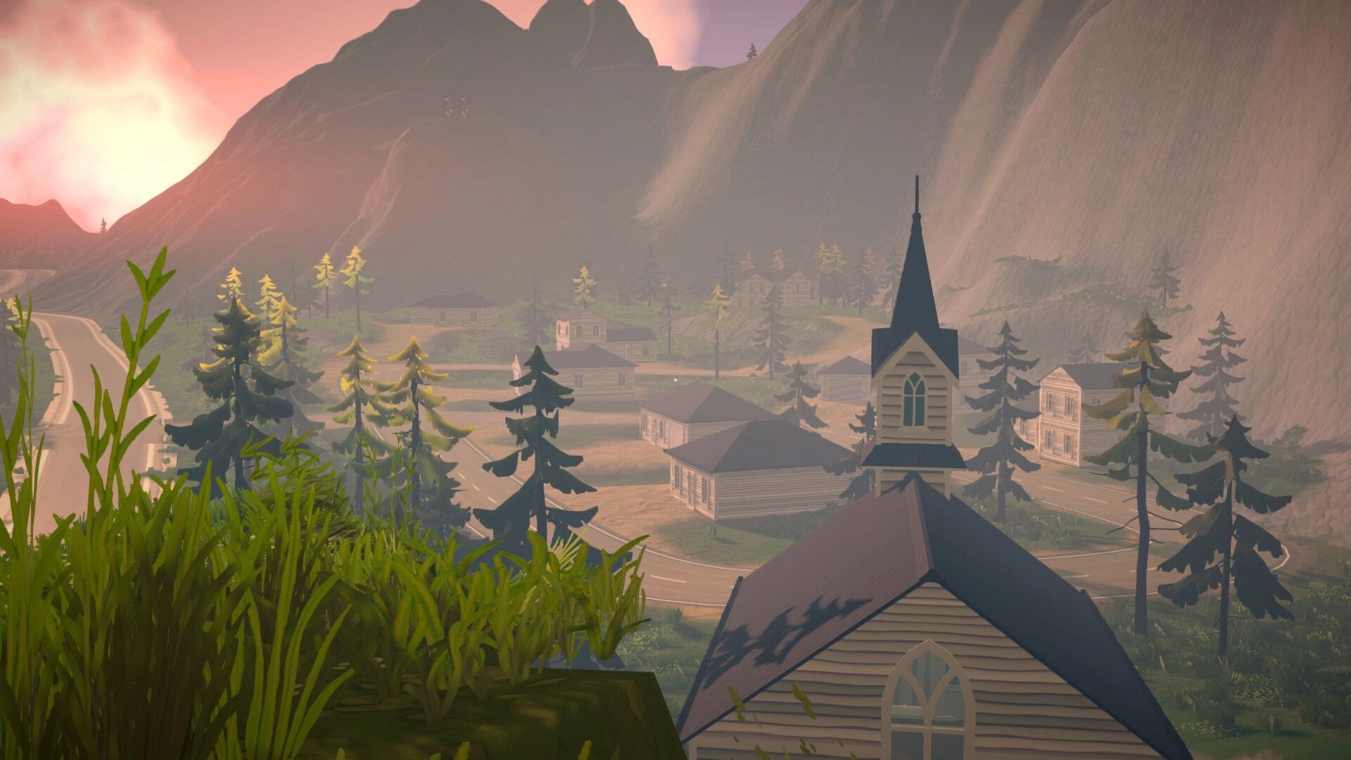 Tie Down: Overlook of small town with church steeple and winding roads in misty mountain valley.