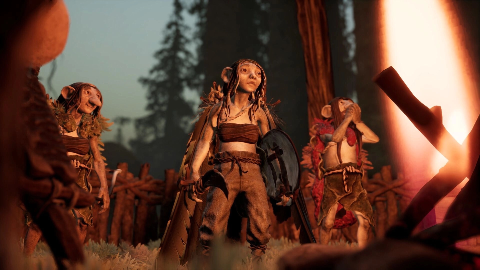 TROLLHEIM: Three gnome villagers by a campfire, one holding a shield, in a misty forest camp.