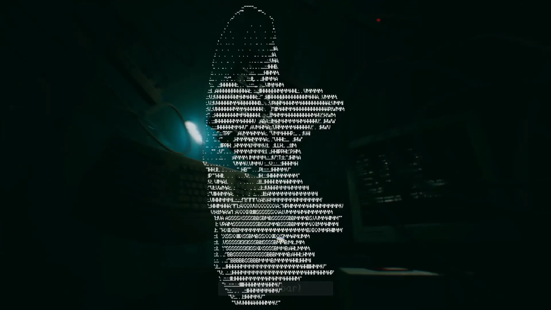 Turnout: ASCII face emerges from computer screen in dimly lit subway control room with monitors nearby