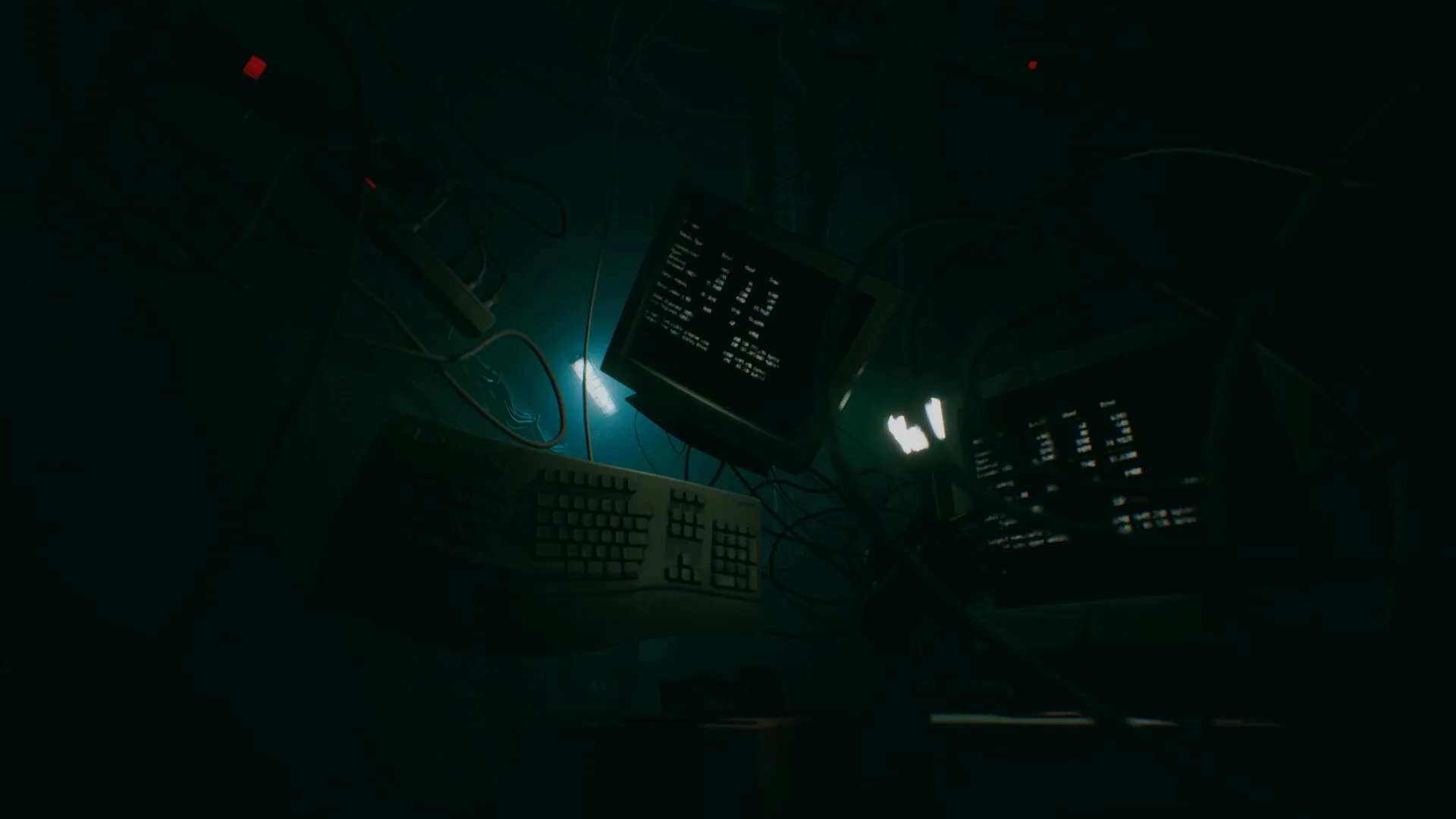 Turnout: Suspended monitors and keyboards in a dark, tangled network of cables within subway tunnels