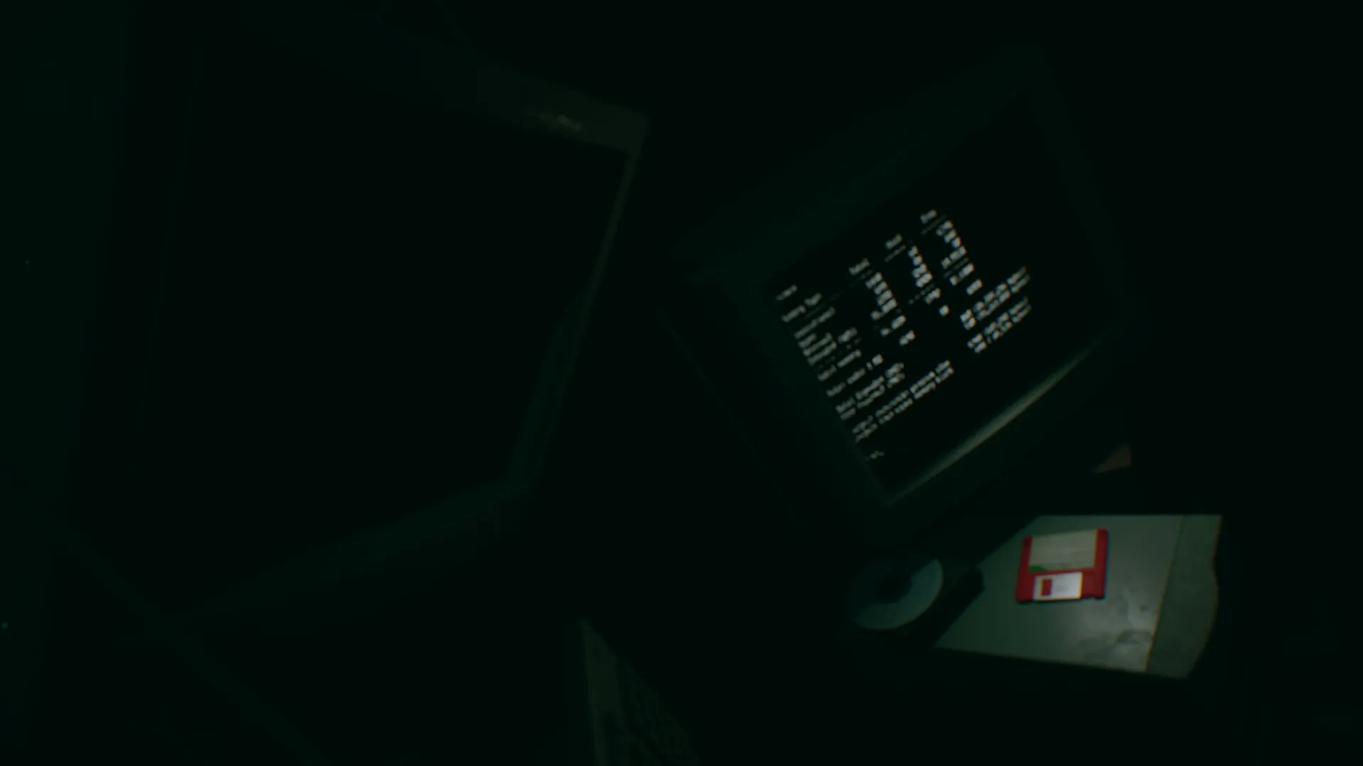 Turnout: Computer monitor displaying code and statistics next to a floppy disk in a dimly lit room