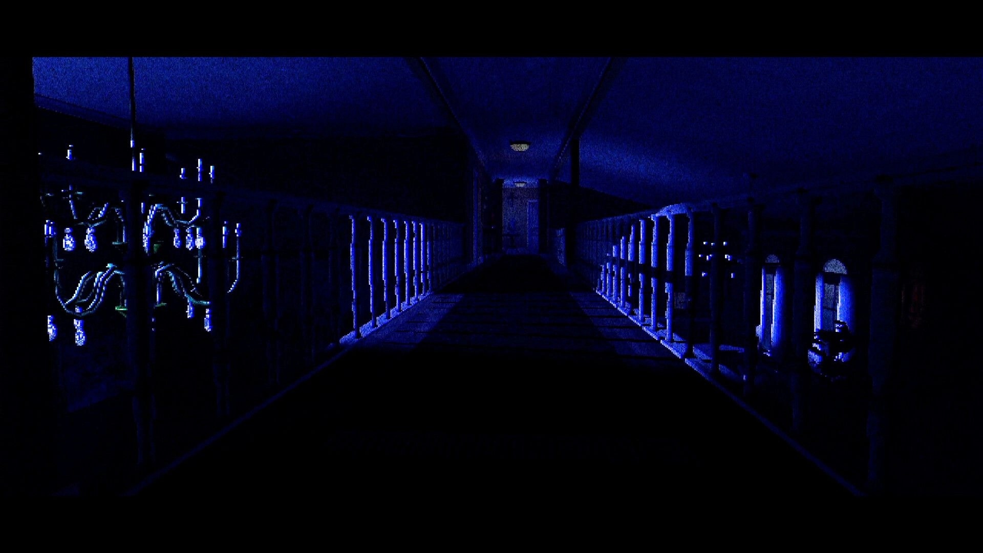 T.W.I.R.L.: First-person view down a blue-lit upstairs hallway with railings and a chandelier ahead.