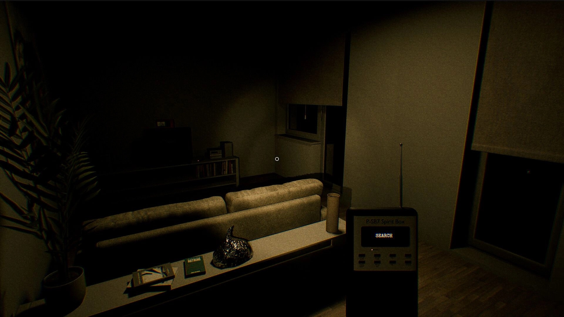 UFOPHILIA: Using spirit box in dimly lit living room with couch, TV, and bookshelves visible
