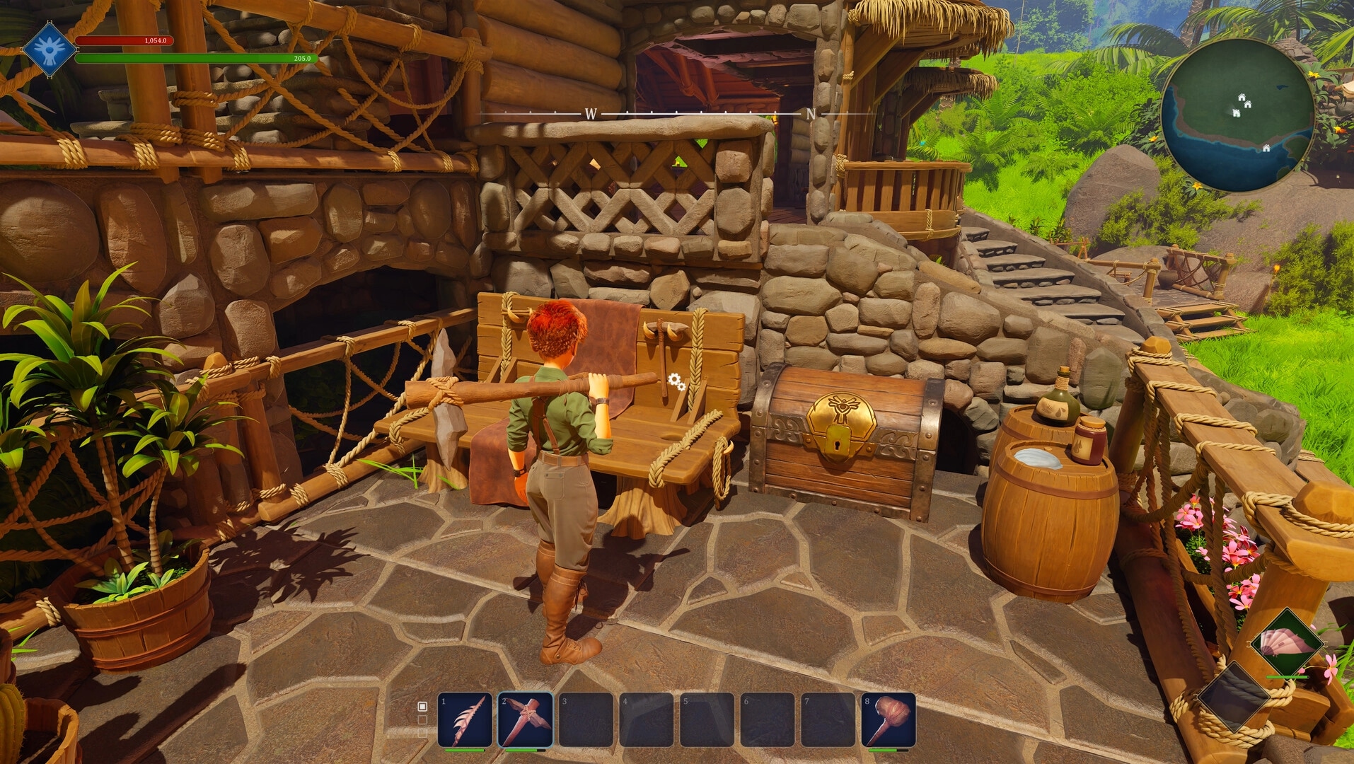 Under a Rock: Player at crafting bench beside loot chest on stone terrace outside a rustic hut UI visible.
