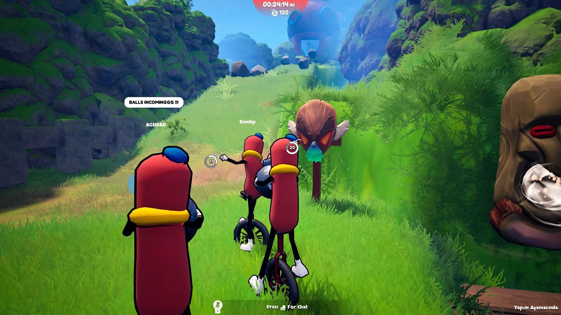 Unicycle Together: Two sausage riders on unicycles dodge rolling boulders on a grassy canyon path.