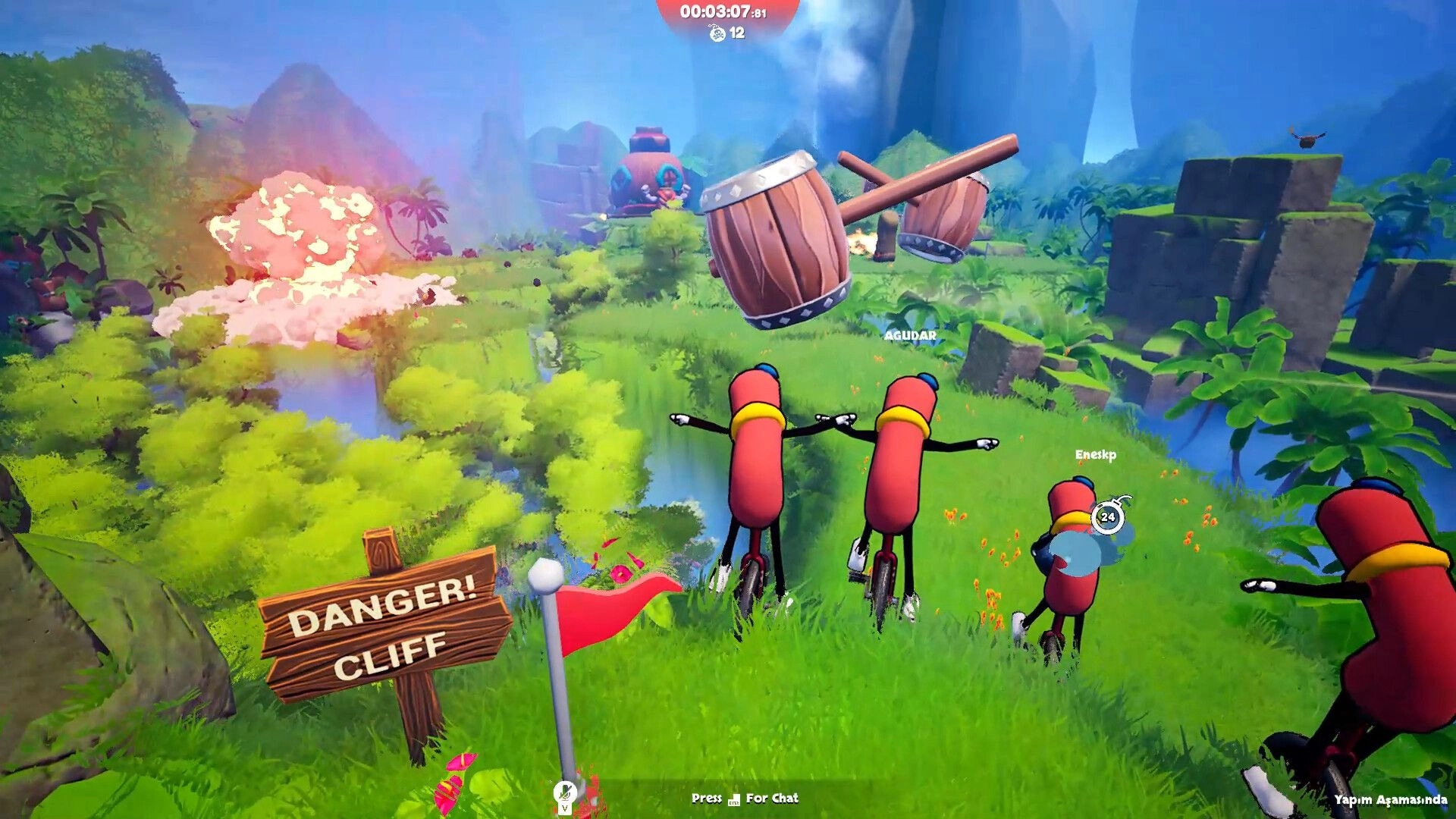 Unicycle Together: Sausage riders on unicycles dodge explosions by a danger cliff sign in jungle valley.