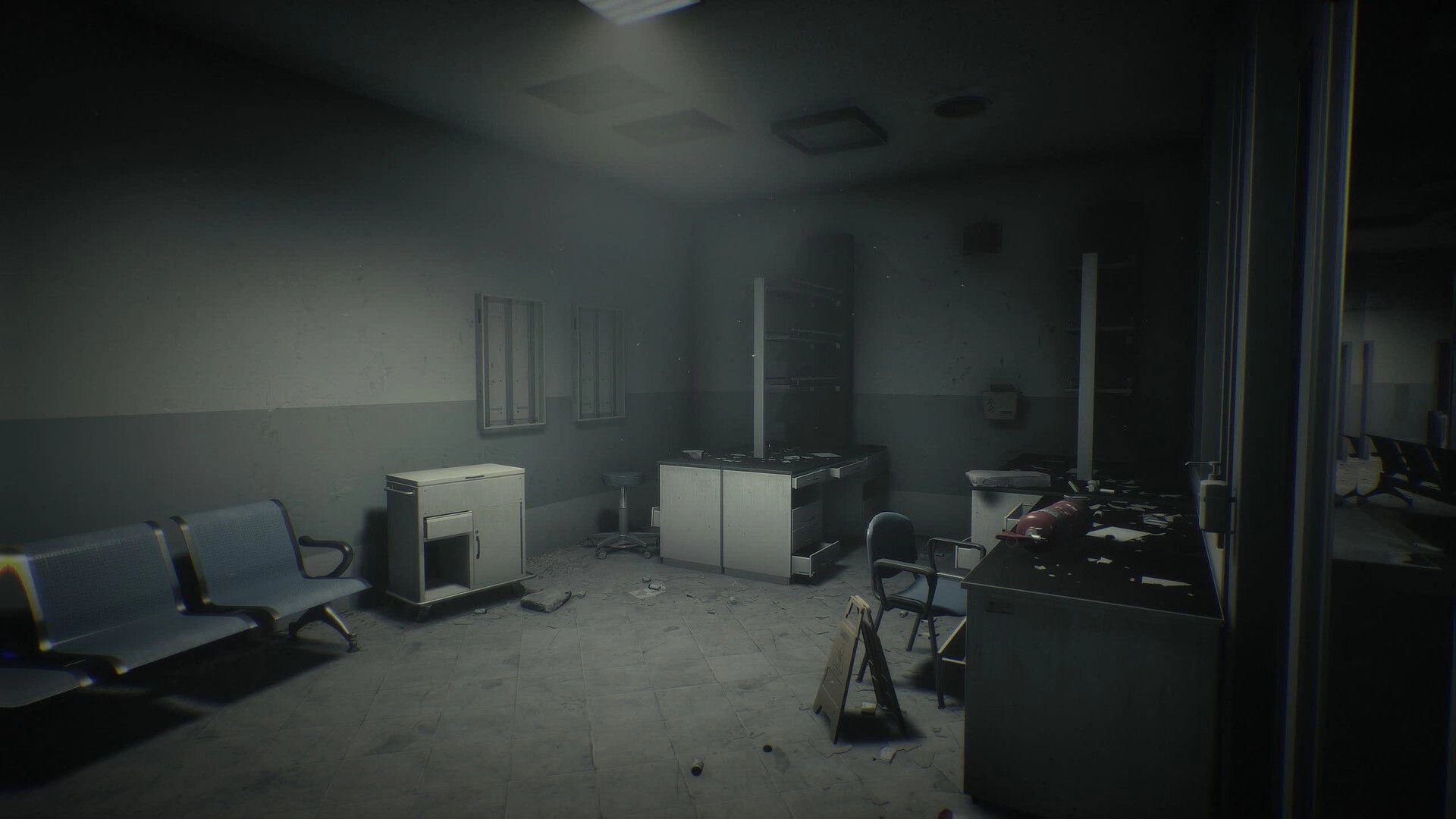 Unlisted: Empty hospital waiting room with scattered debris, desks, and chairs under dim light.