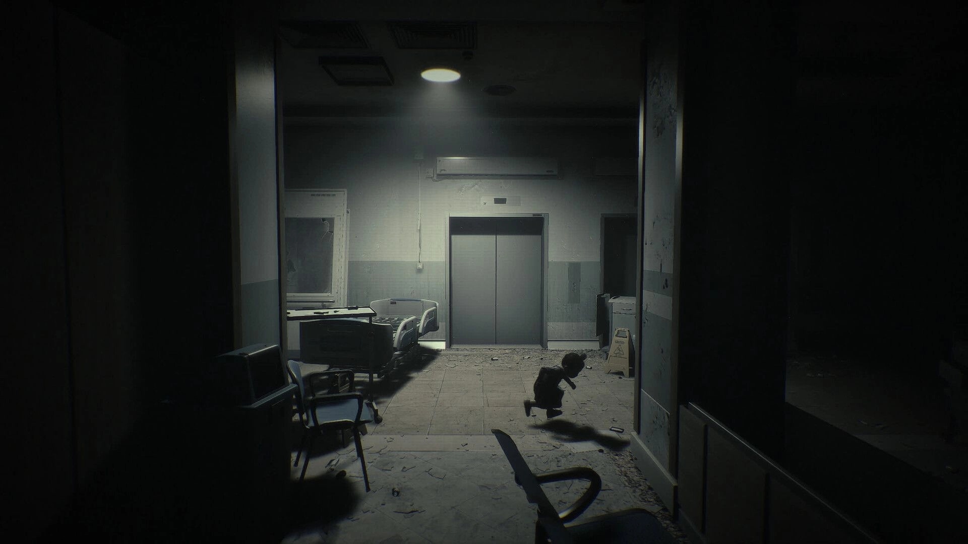 Unlisted: Small child running past debris toward elevator doors in a dim, abandoned hospital hall.