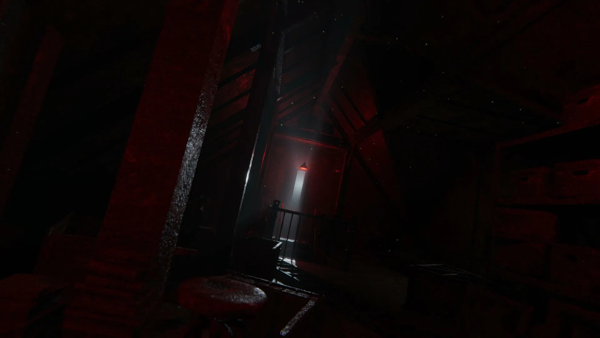 Unmourned: Eerie attic with red lighting and a single window casting light through a shadowy, dusty atmosphere