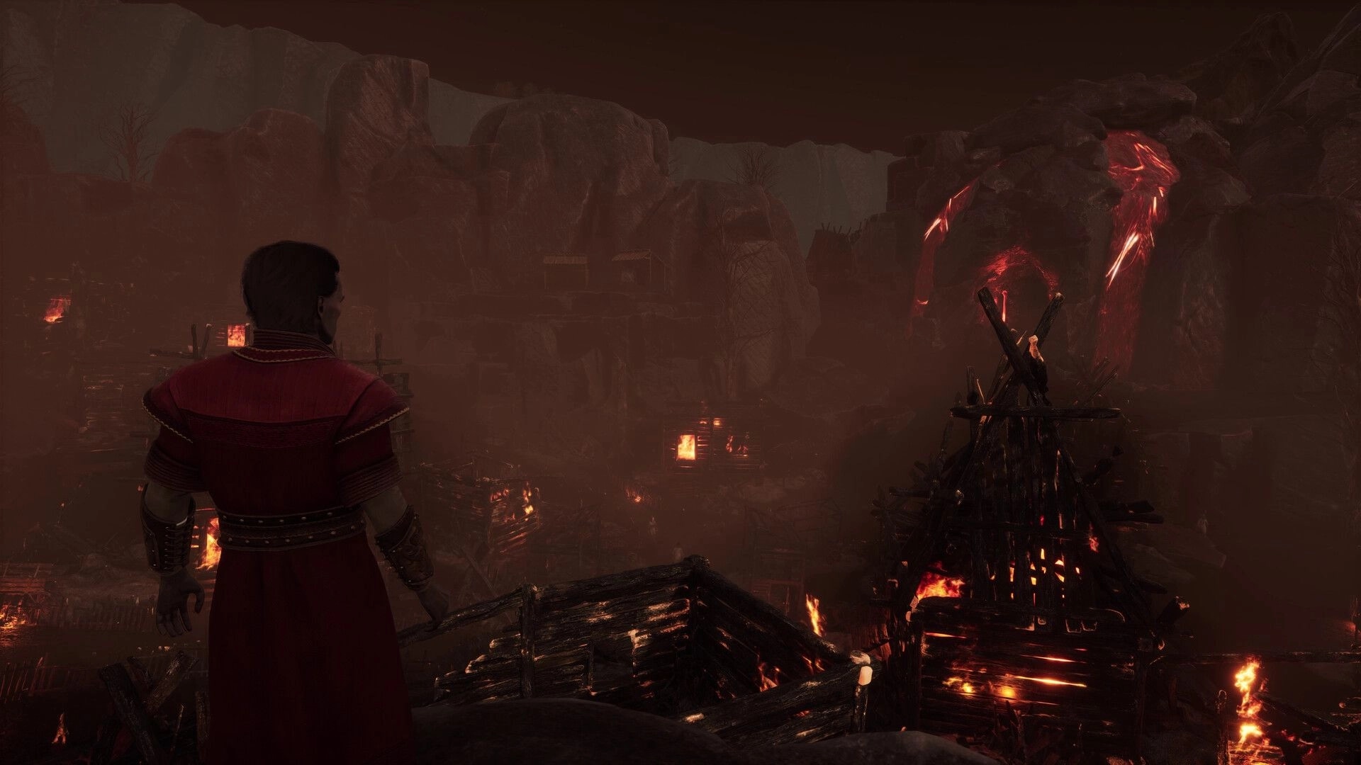 Vampires: Character overlooks burning village in rocky canyon at night, flames illuminating the scene