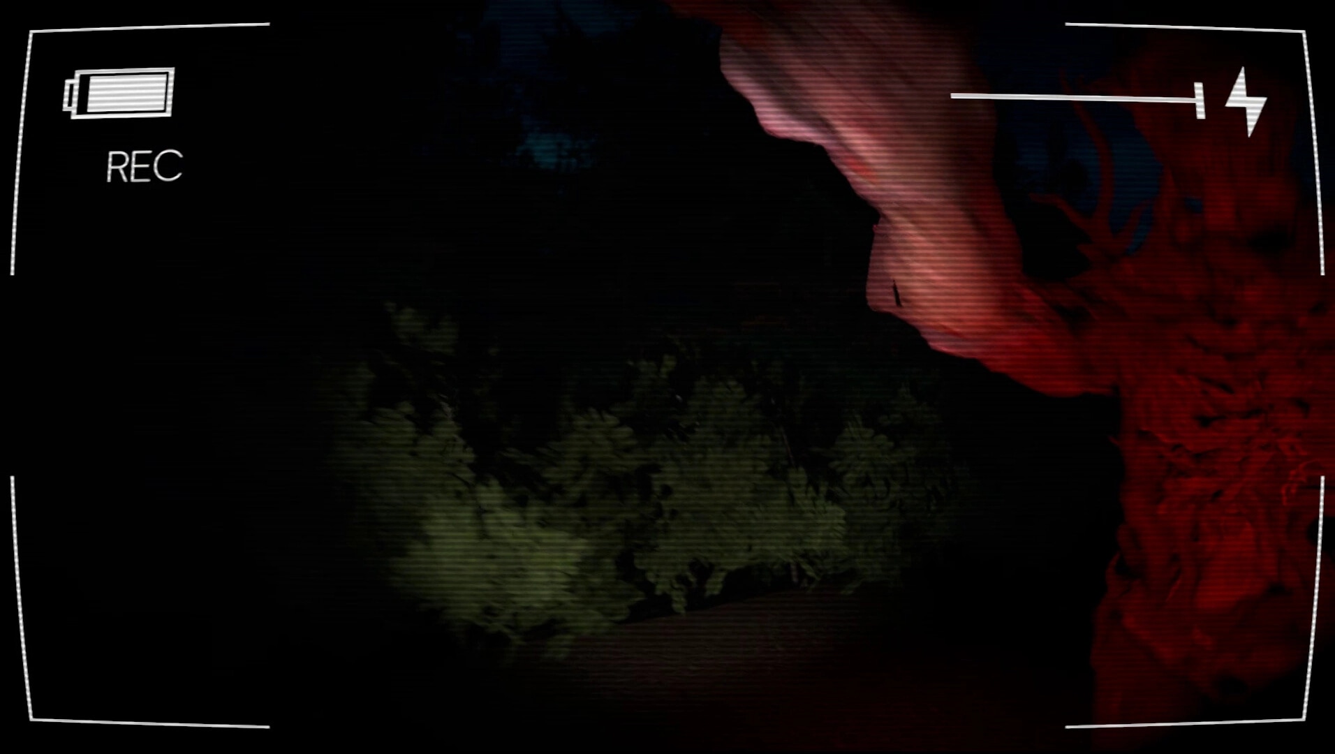 Vicious Cycle: Red creature encounter in dark forest, recorded with low battery camera interface visible
