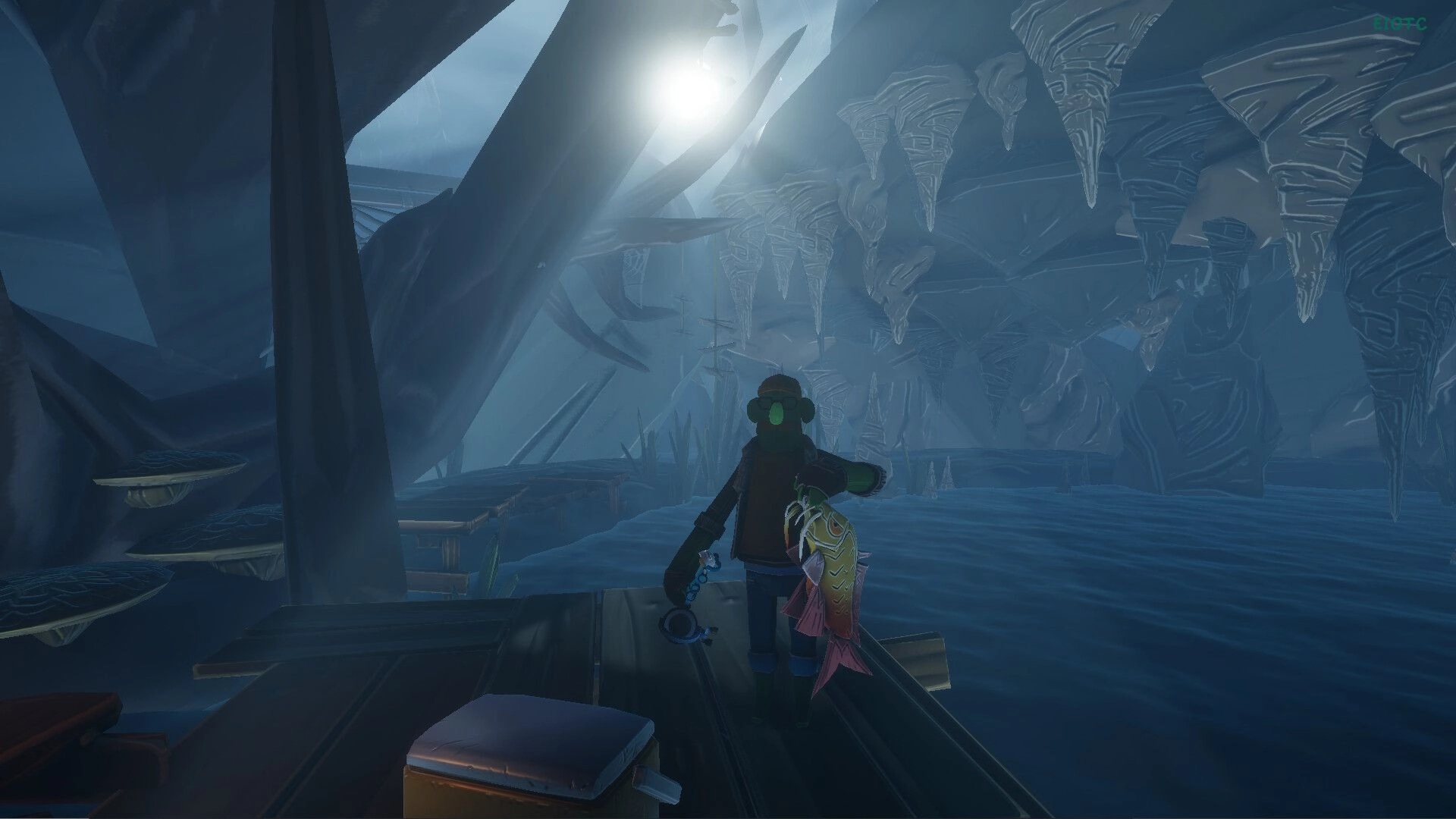 Voodoo Fishin': Player holding a large fish on a wooden dock in a misty cave with stalactites overhead.