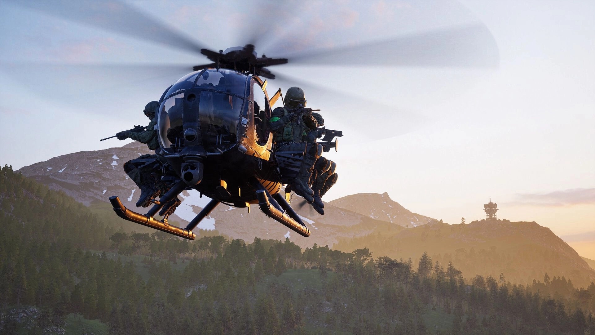 WARDOGS: Helicopter insertion with two armed soldiers on skids over forested mountains at sunset.