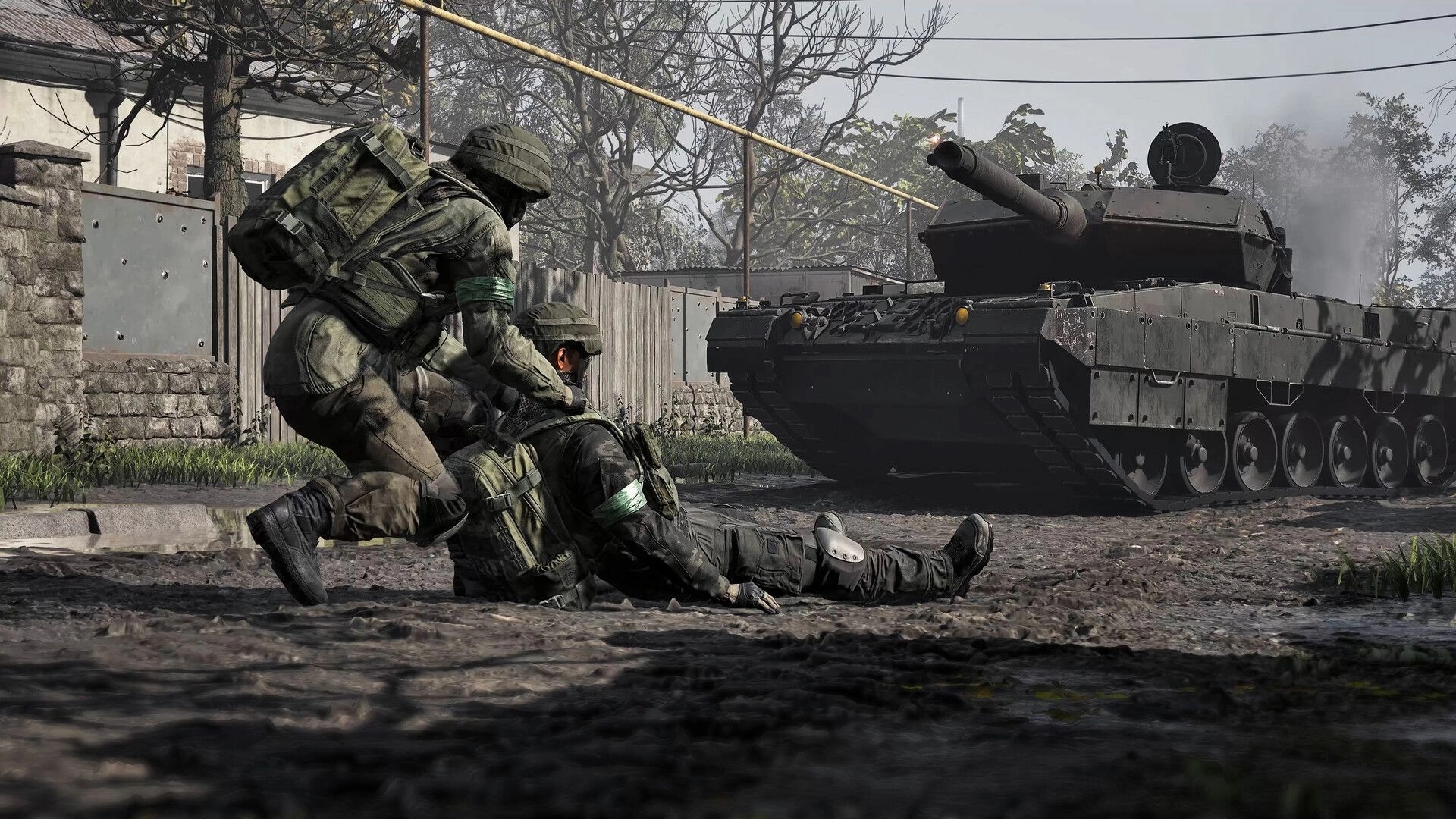 WARDOGS: Soldier drags a wounded teammate along muddy road as a tank rumbles past village fences.