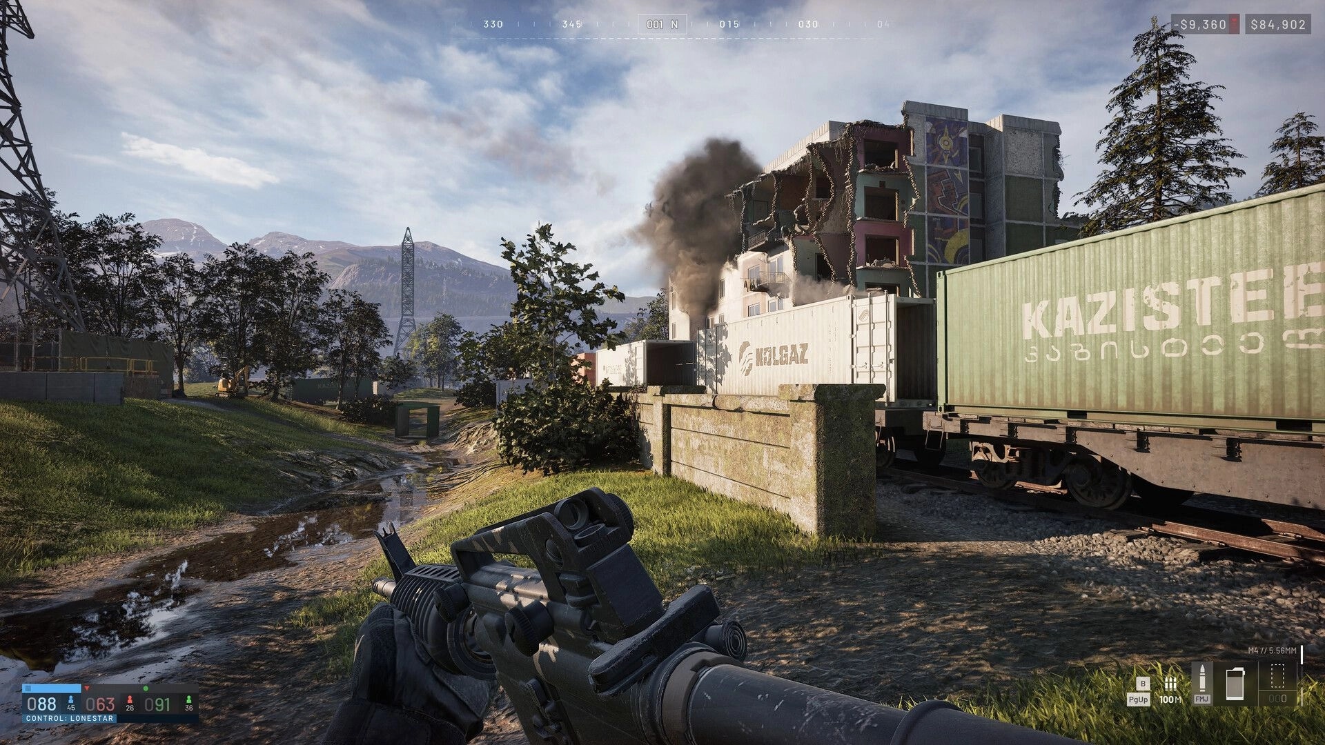 WARDOGS: First-person rifle view with cash HUD and compass near smoking ruined factory by rail cars.