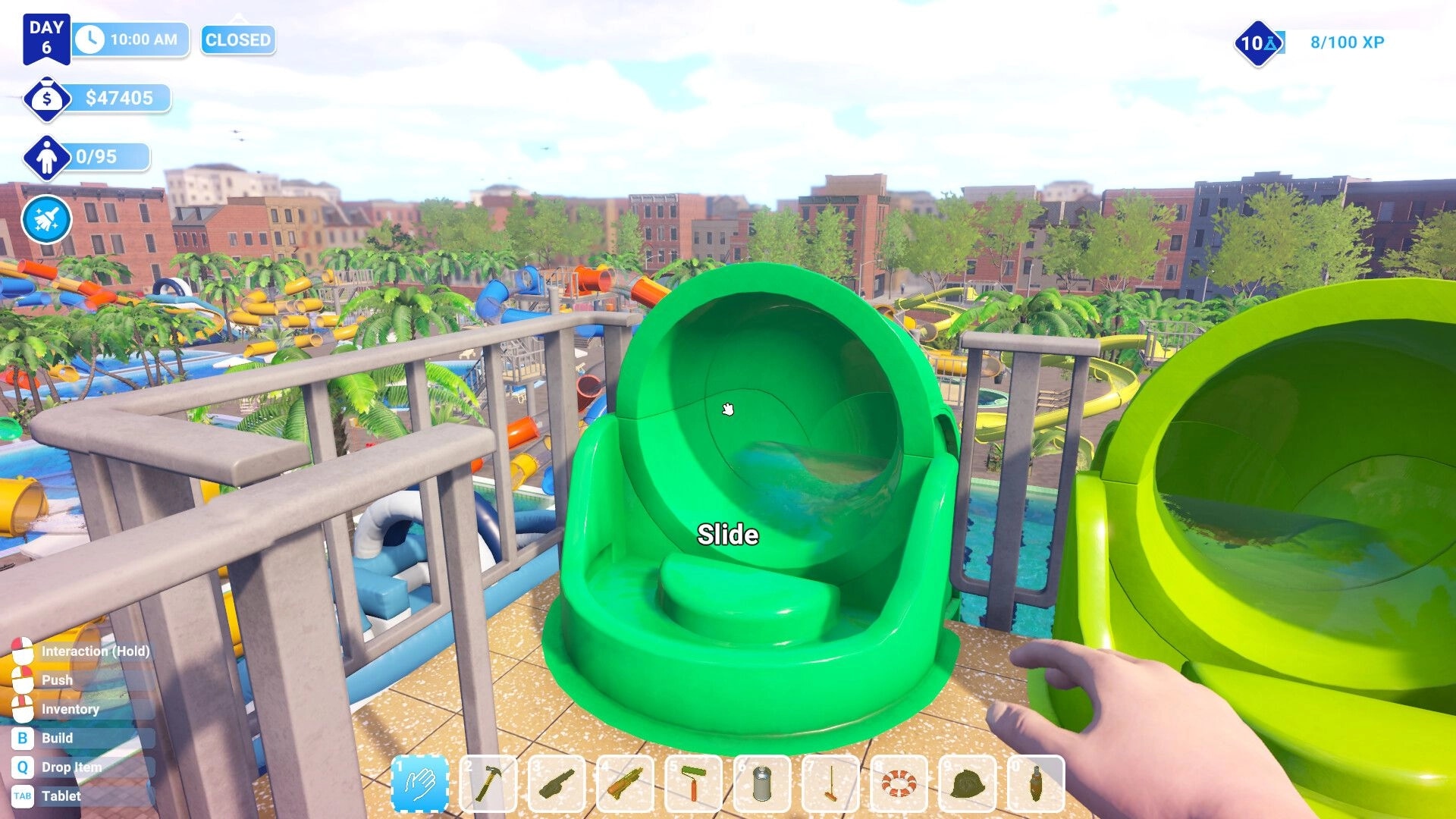 Waterpark Simulator: First-person view of green slide entrance with UI showing time, money, and inventory