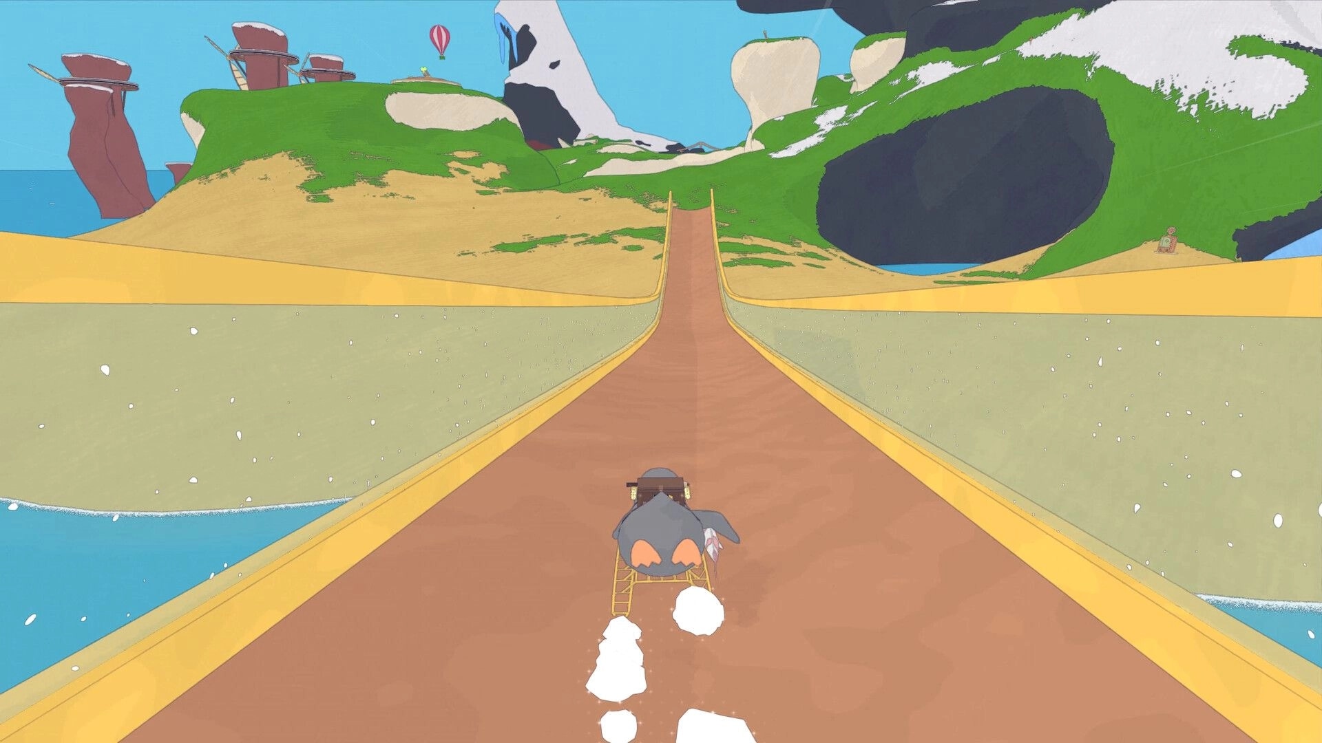 Whelm: Player rides a cart with a creature on a sandy path towards cliffs and a distant hot air balloon
