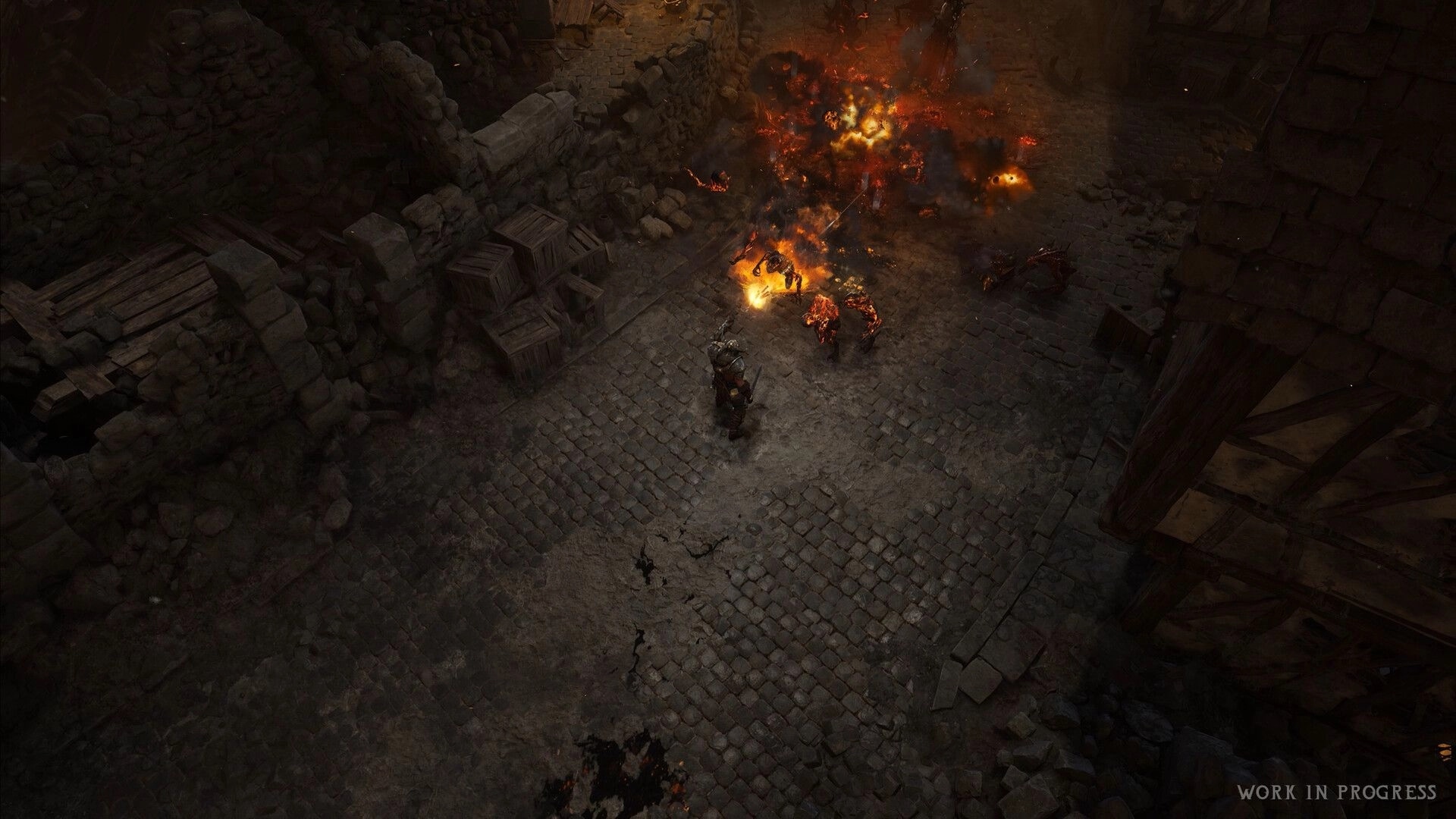 Wolcen 2: Warrior battles fiery demons amid explosions in a ruined stone alley with crates and rubble.