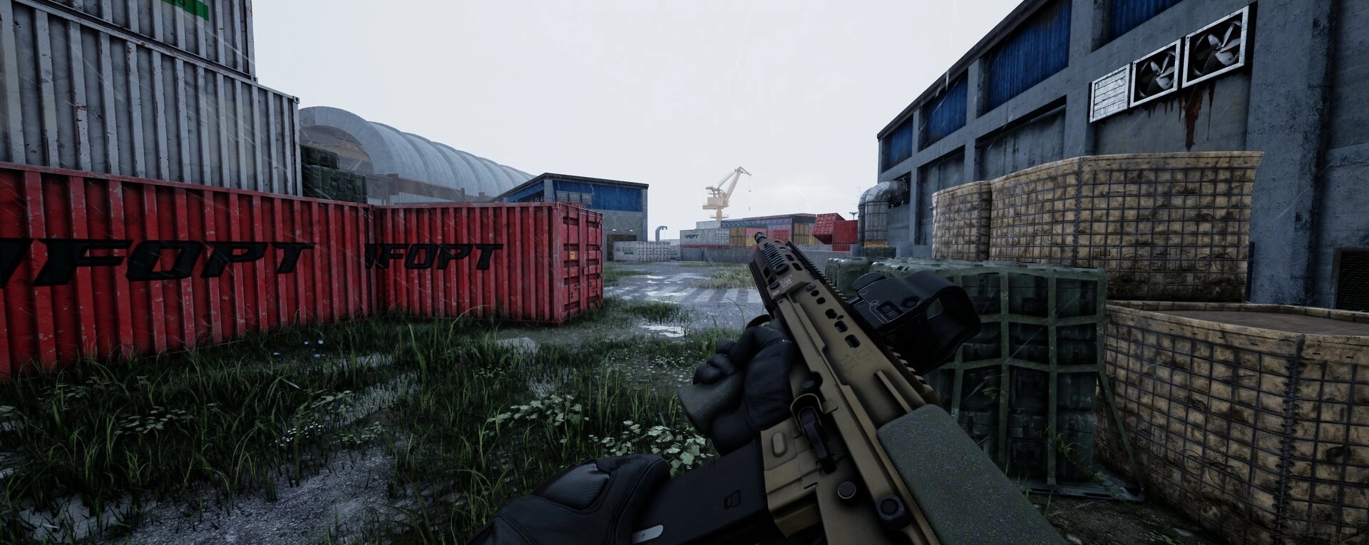 WRAITH OPS: Player holds rifle near red shipping containers in an industrial yard with overcast sky
