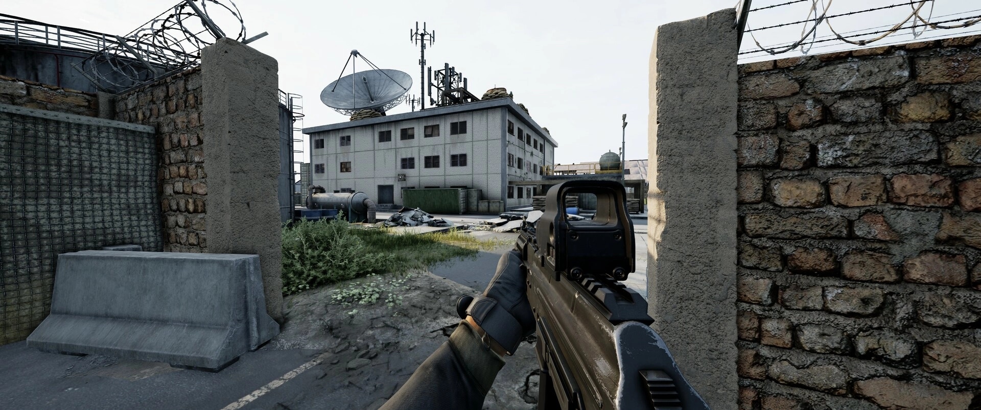 WRAITH OPS: Player aiming rifle at industrial building with satellite dish, surrounded by barbed wire fences